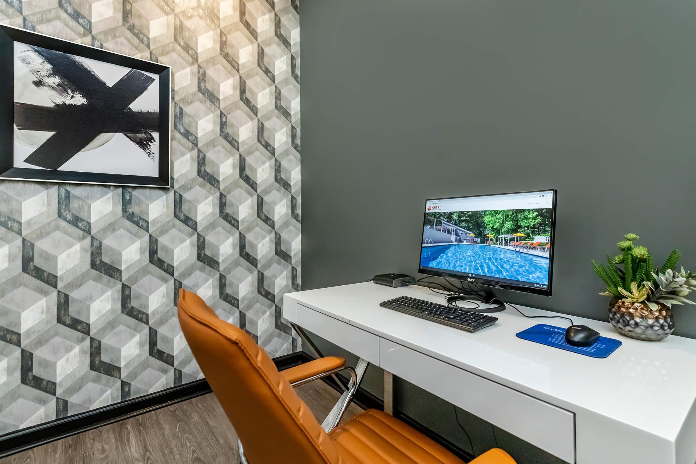 a desk with a laptop computer sitting on top of a table