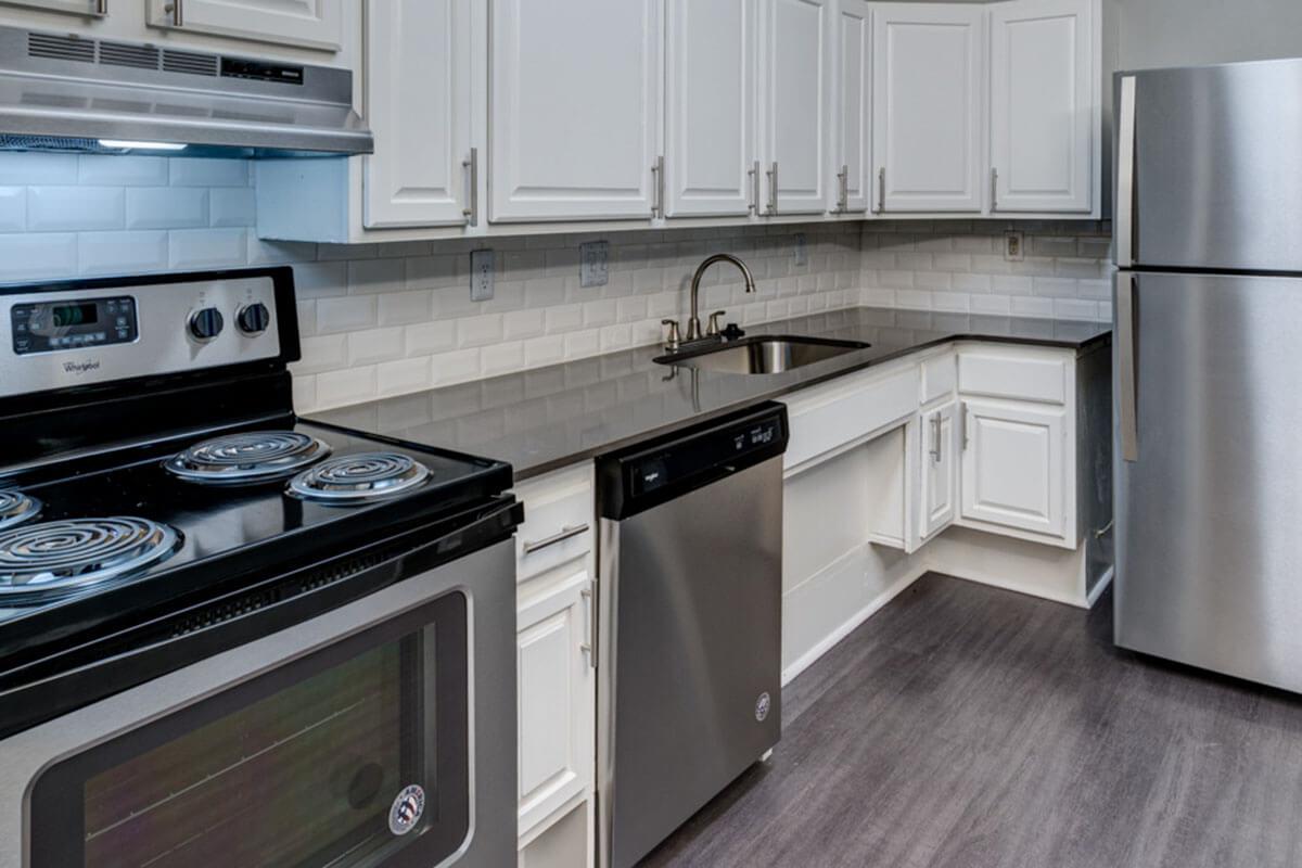 a stove top oven sitting inside of a kitchen