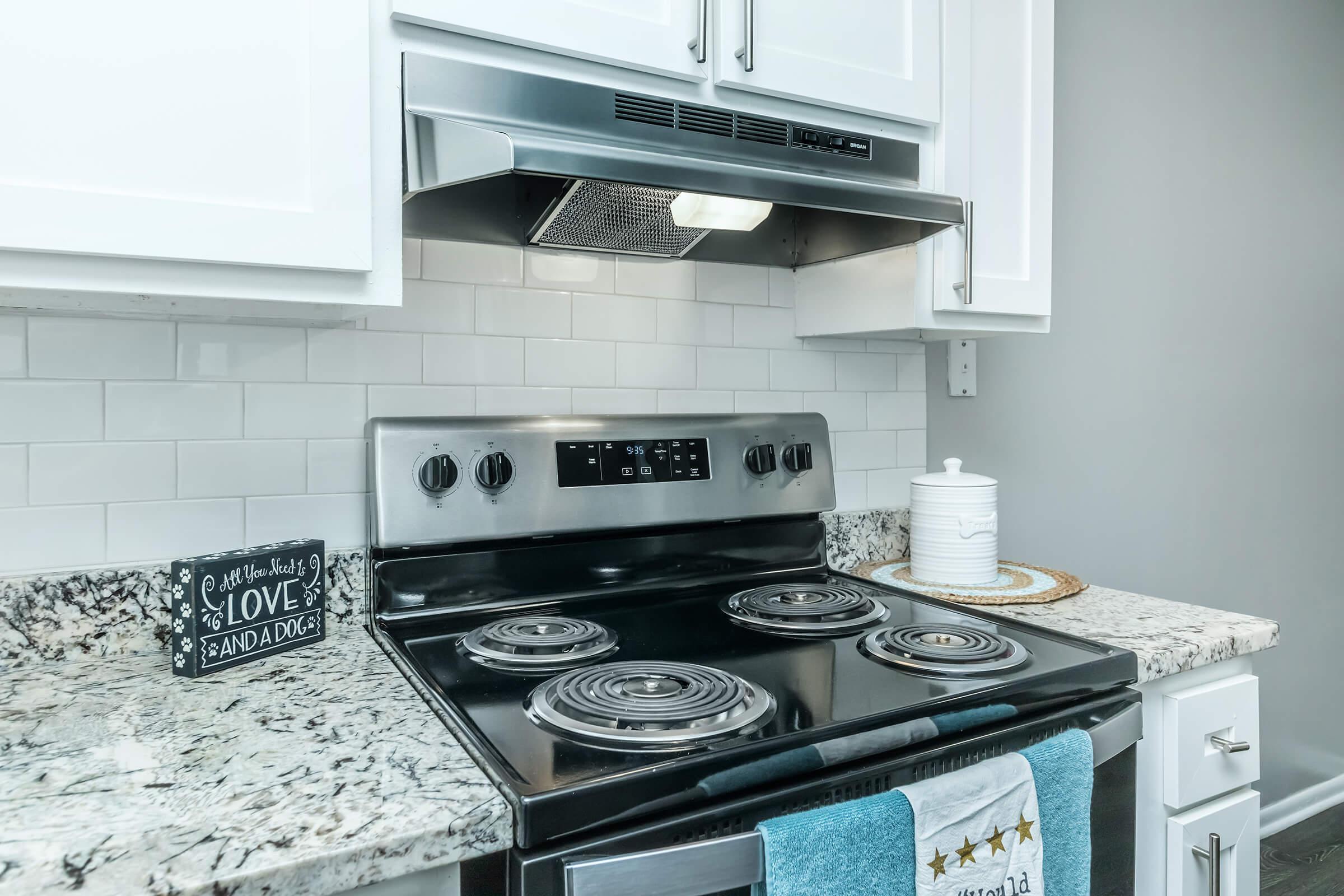 a stove top oven sitting inside of a kitchen