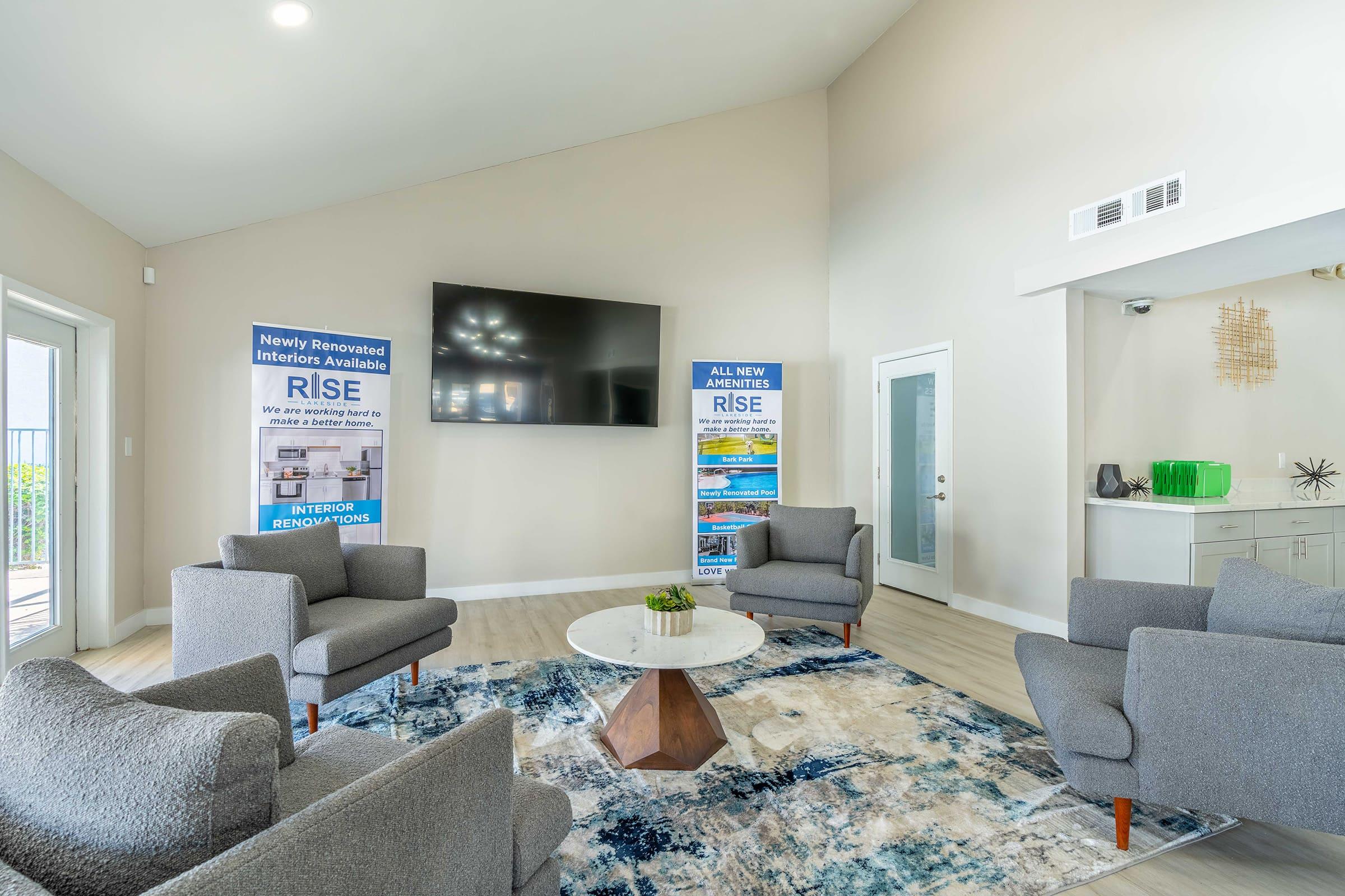 a living room filled with furniture and a flat screen tv