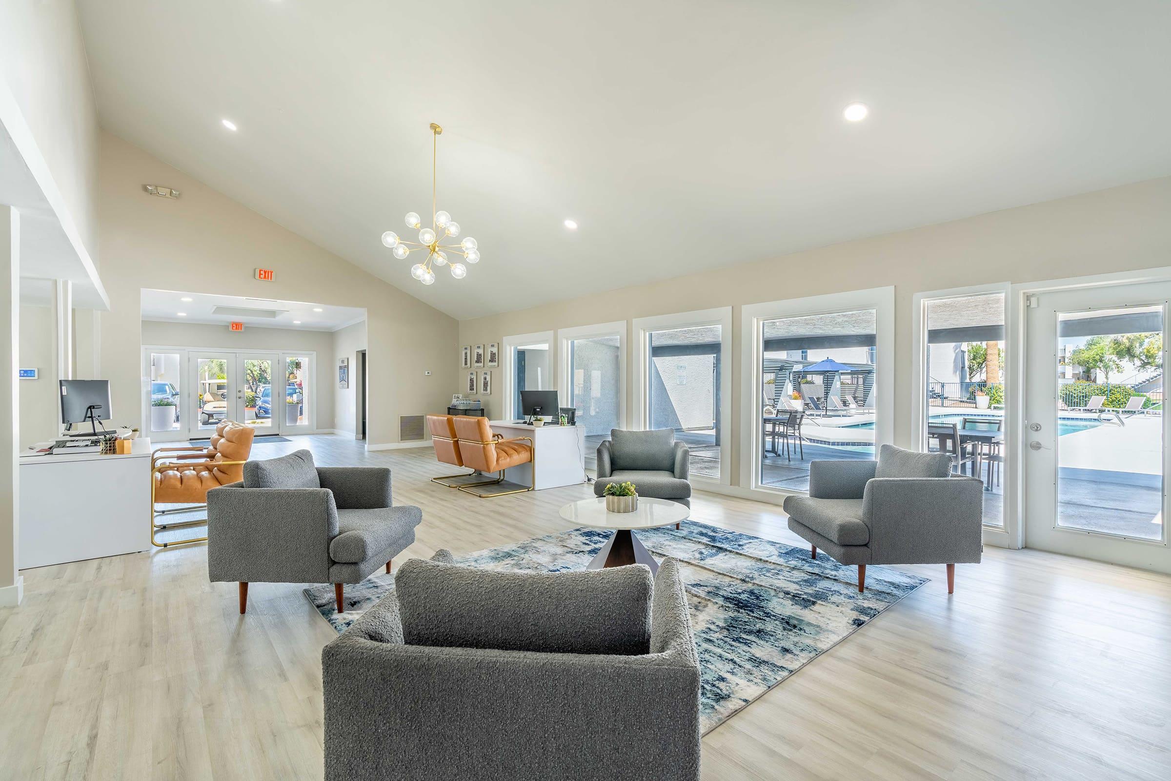 a living room filled with furniture and a large window