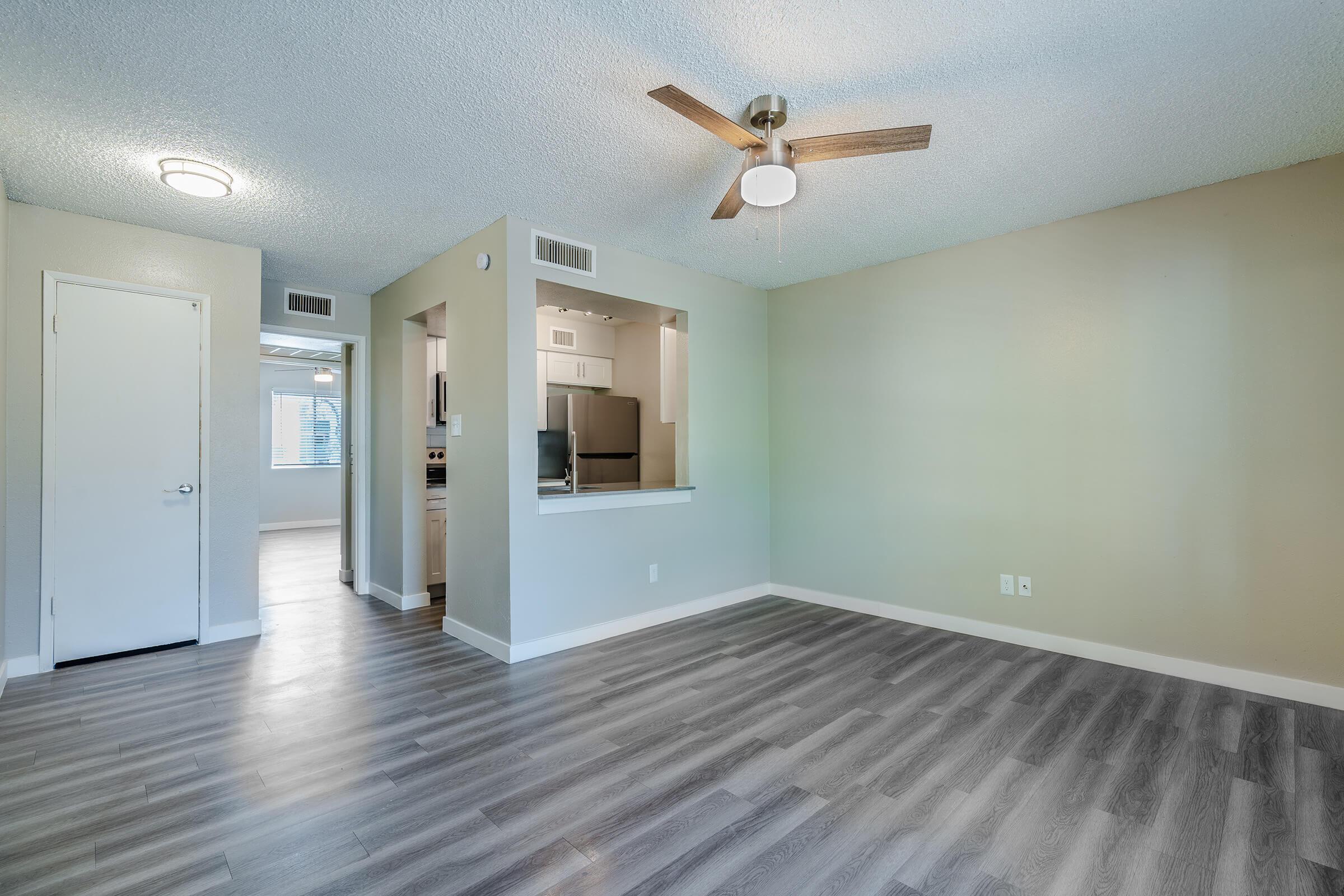 Open spacious living room with a view of the kitchen