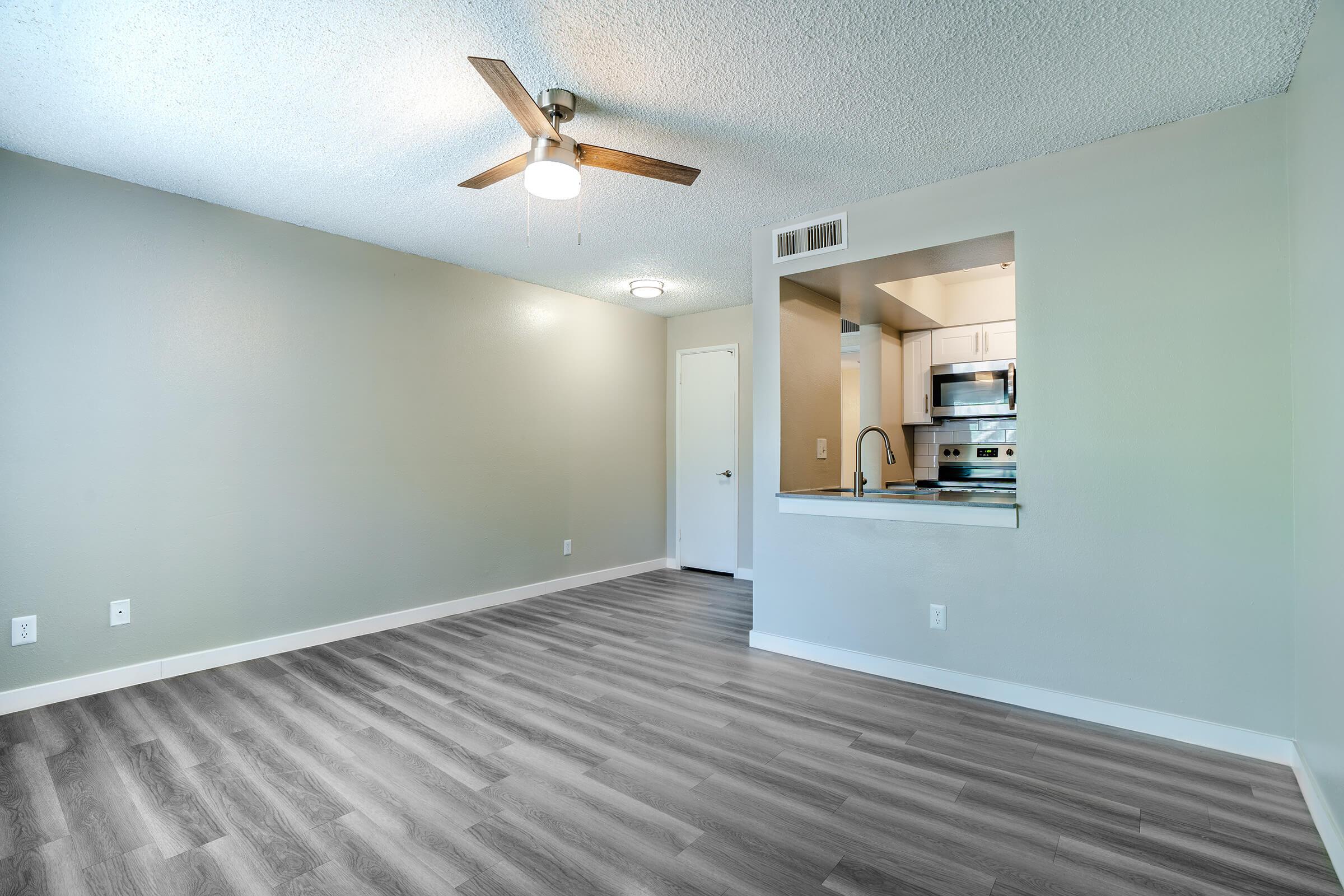 Open spacious living room with a view of the kitchen