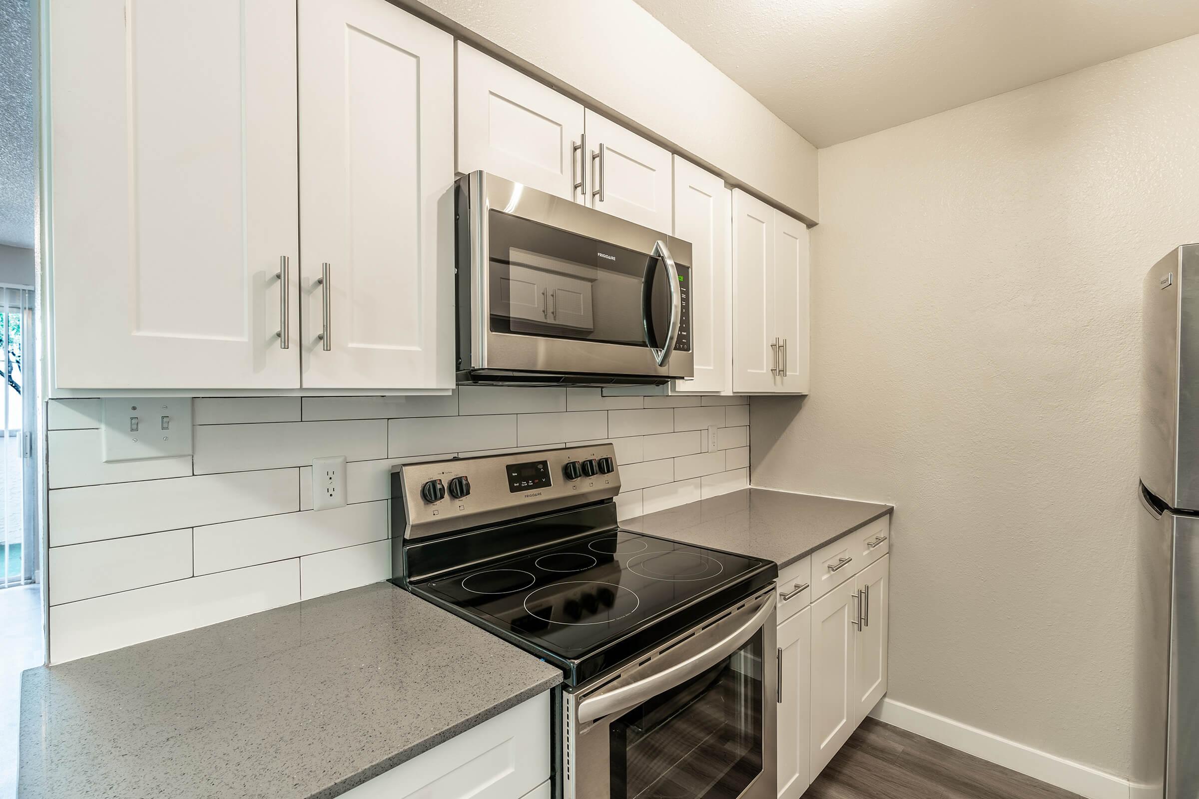 Close up of kitchen cabinets and stainless steel appliances