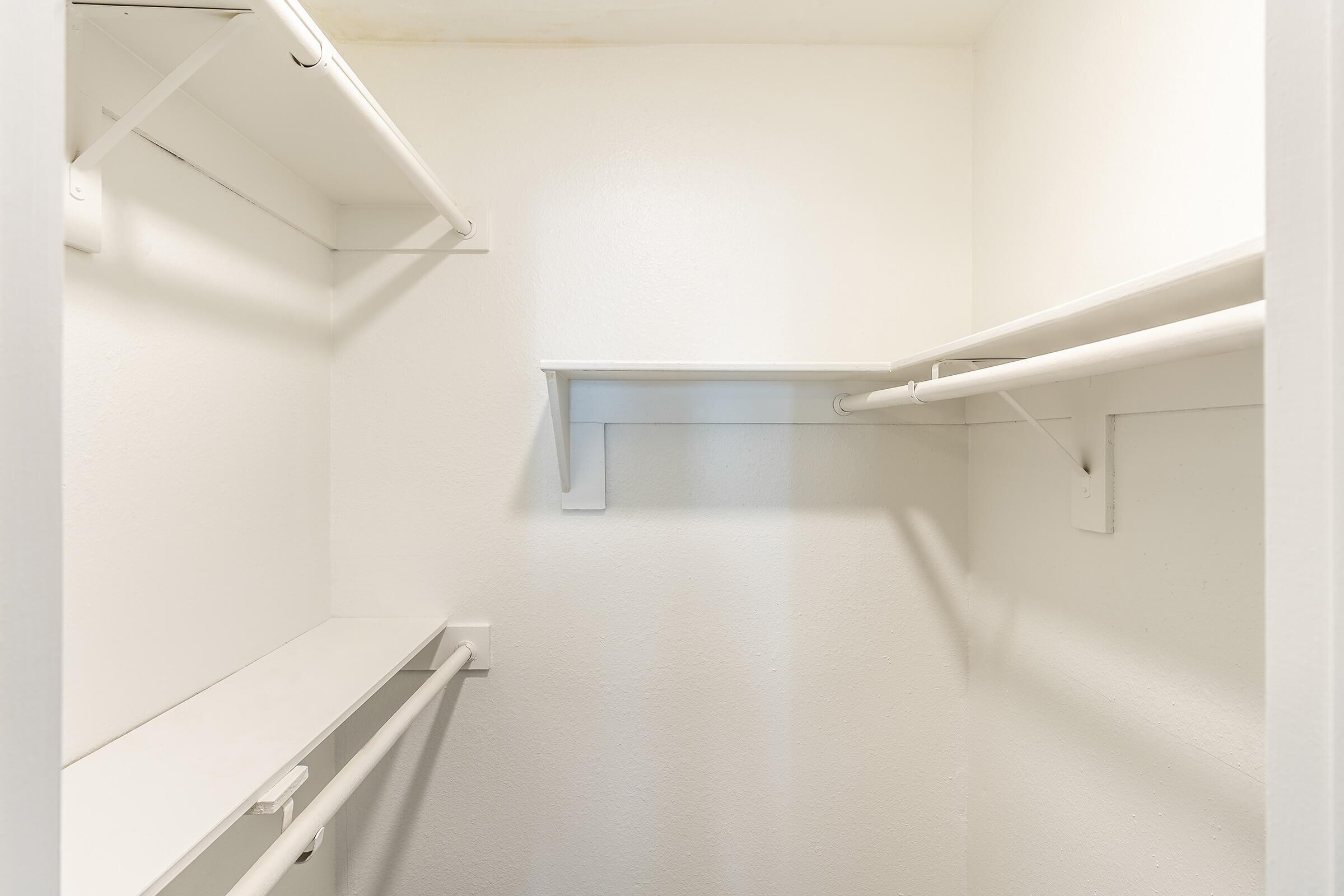 Inside a walk in closet with built in shelving