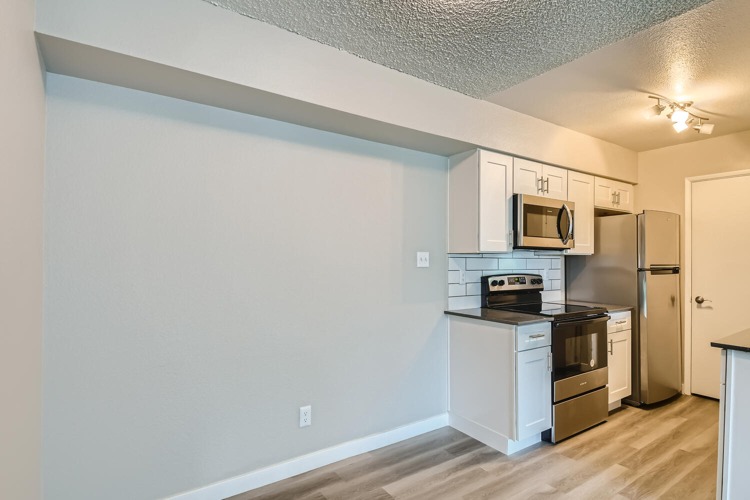 a kitchen with a sink and a refrigerator