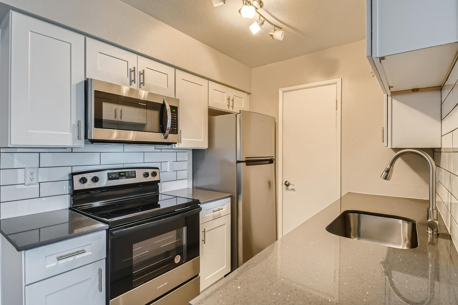 a large kitchen with stainless steel appliances