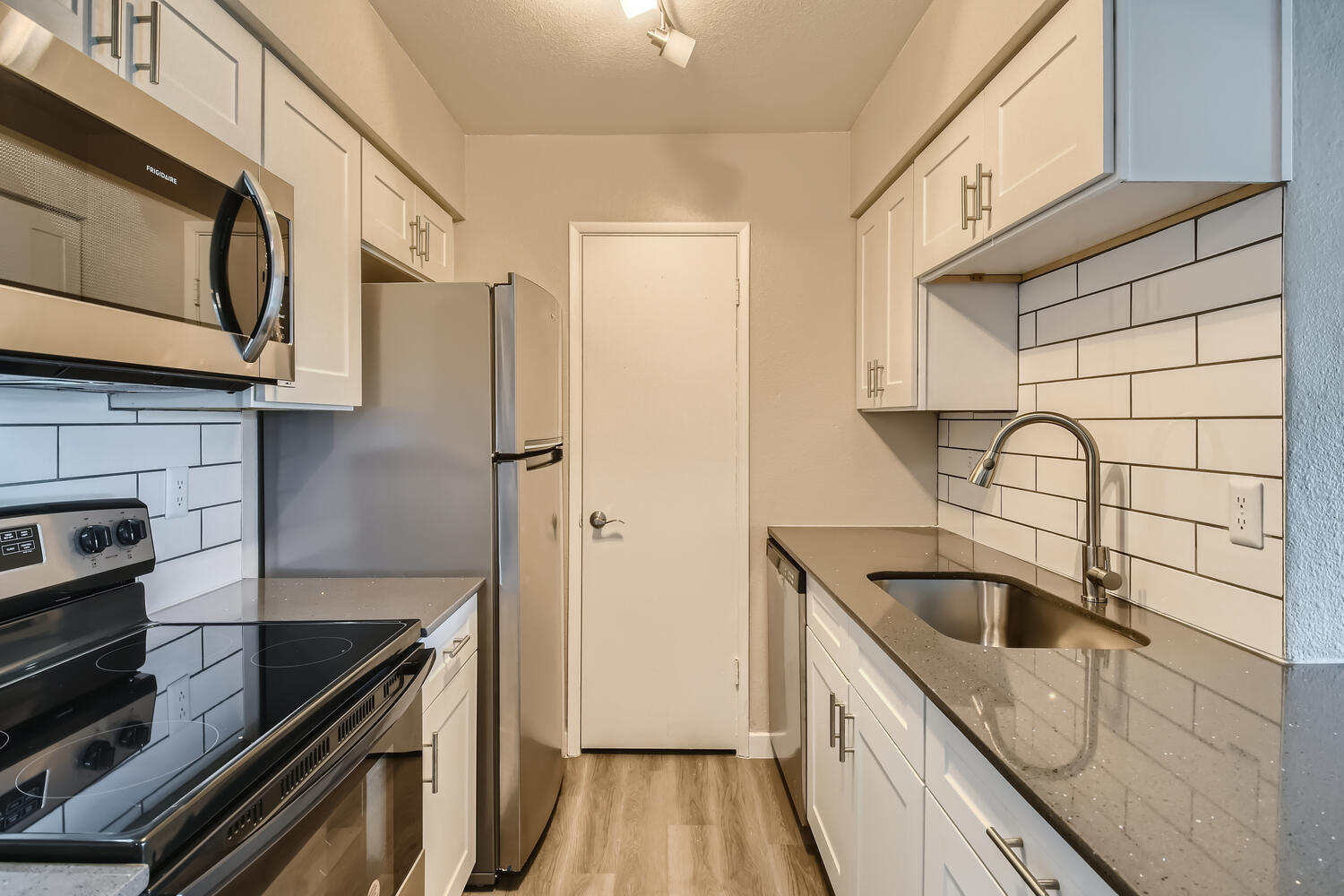 a stove top oven sitting inside of a kitchen