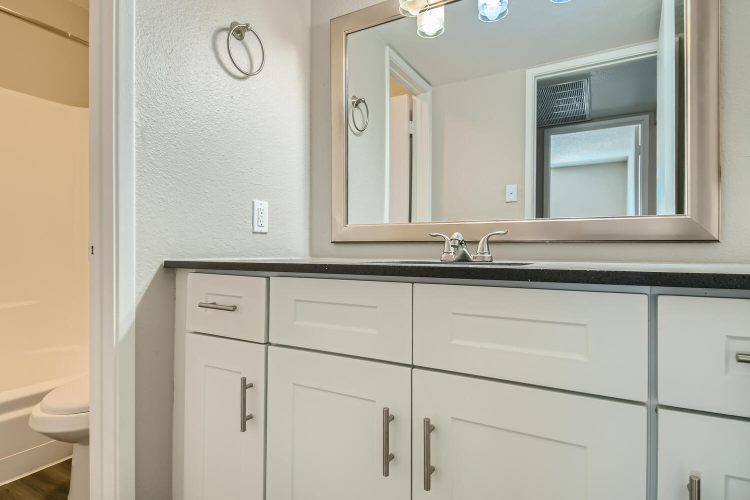 a kitchen with a sink and a mirror