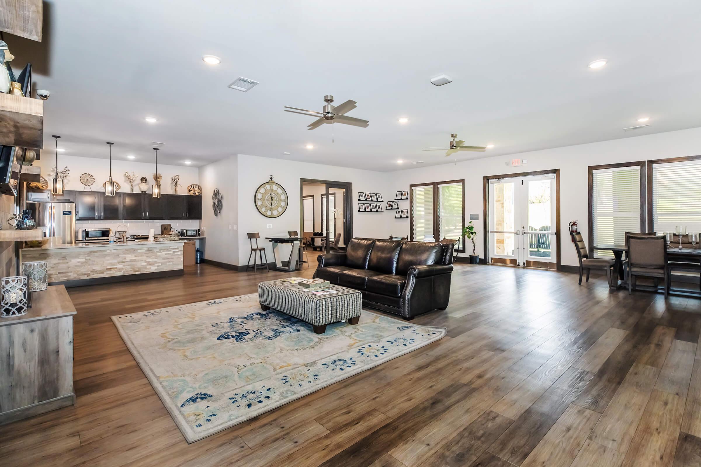 a living room filled with furniture and a wood floor