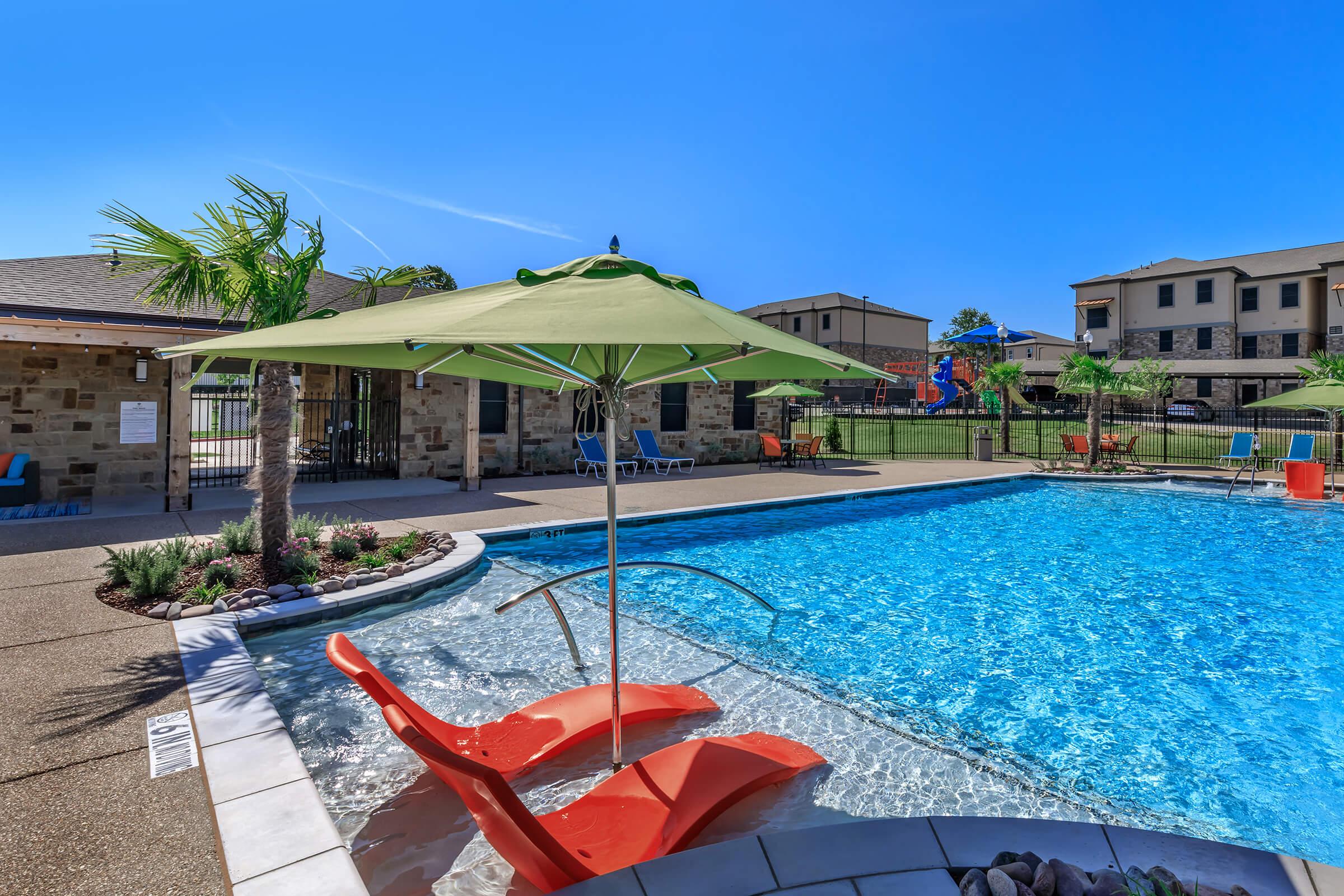 a house that has a umbrella in a pool of water