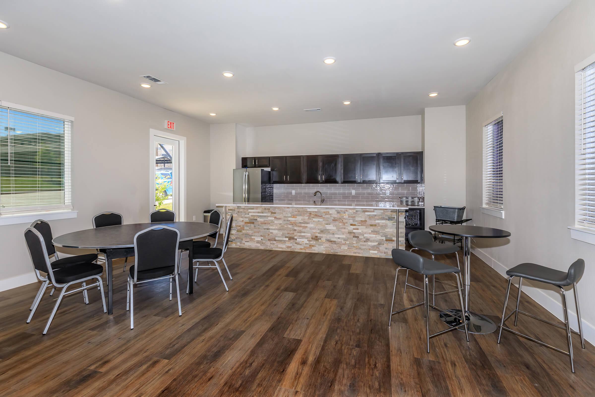 a living room filled with furniture and a wood floor