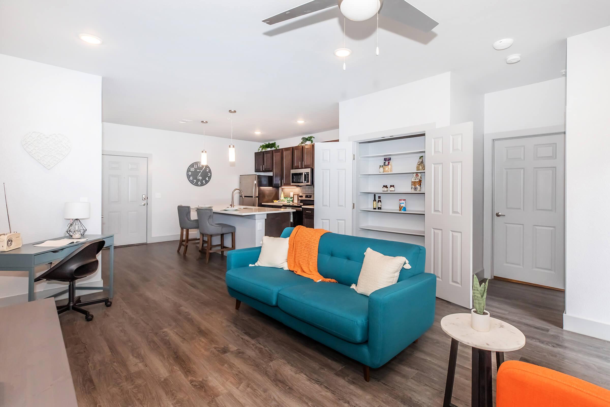 a living room filled with furniture and a flat screen tv