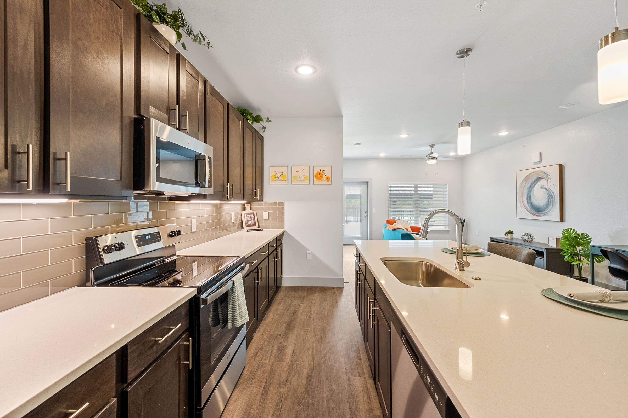 a kitchen with a sink and a mirror