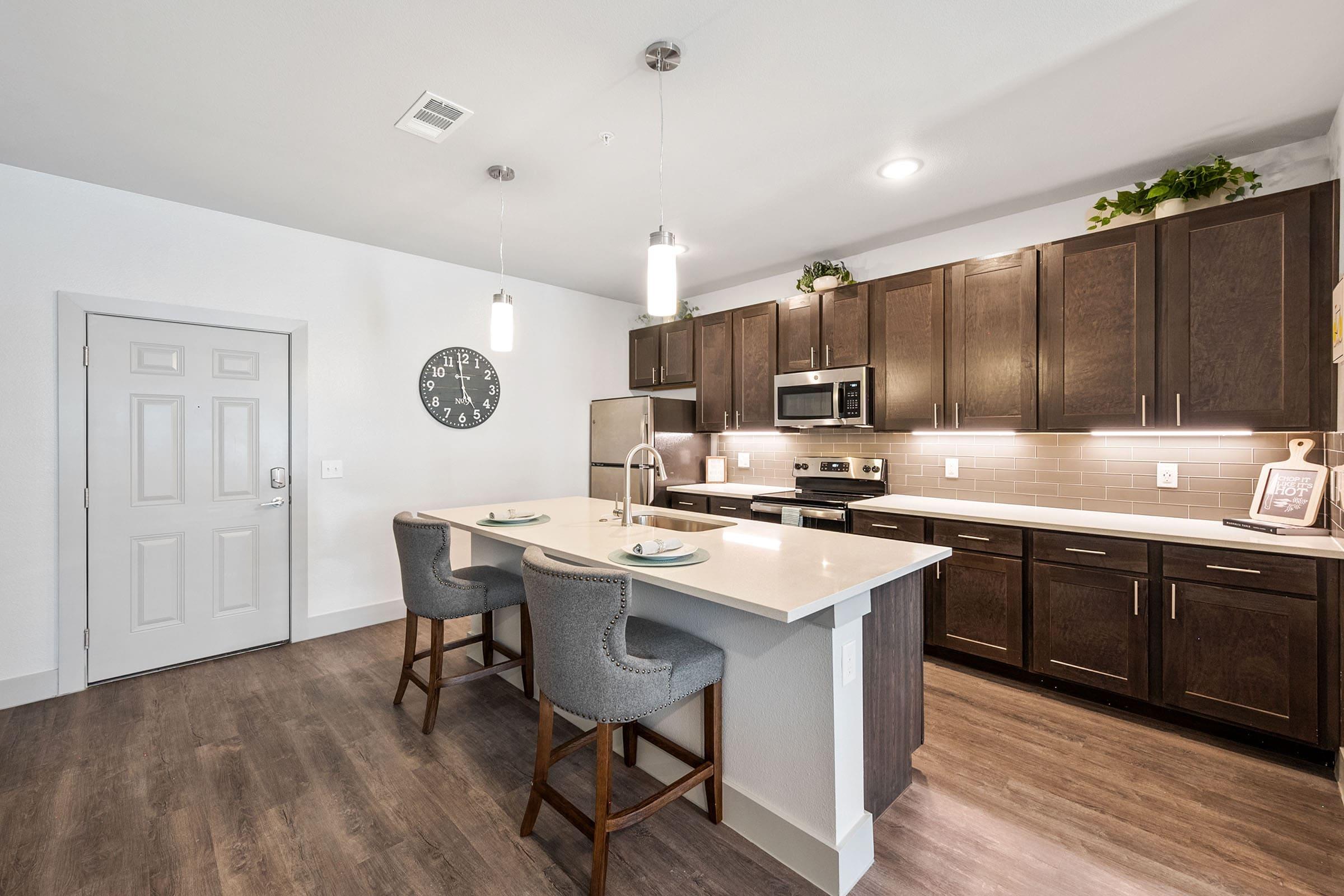 a kitchen with a wood floor in a room