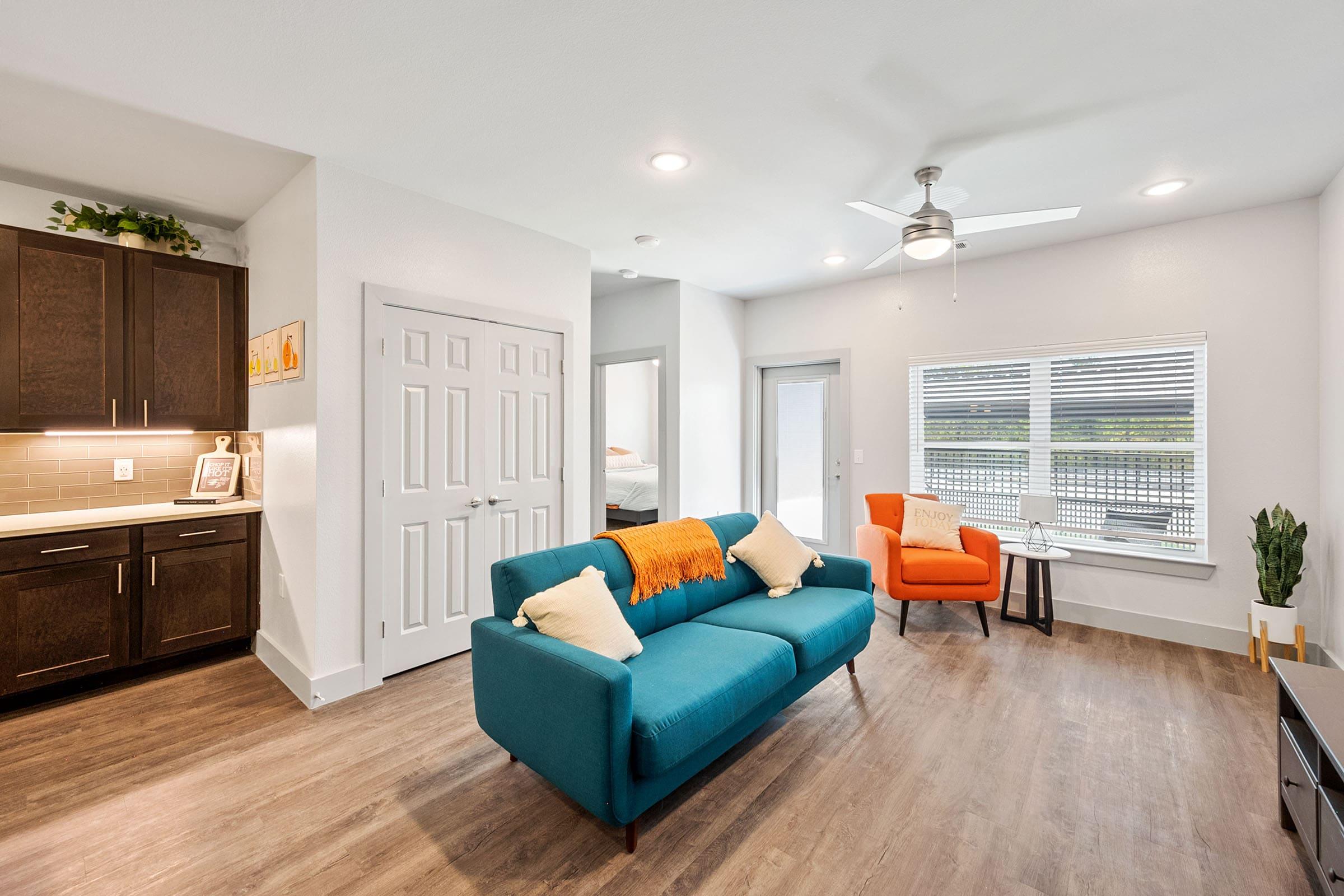 a living room filled with furniture and a flat screen tv