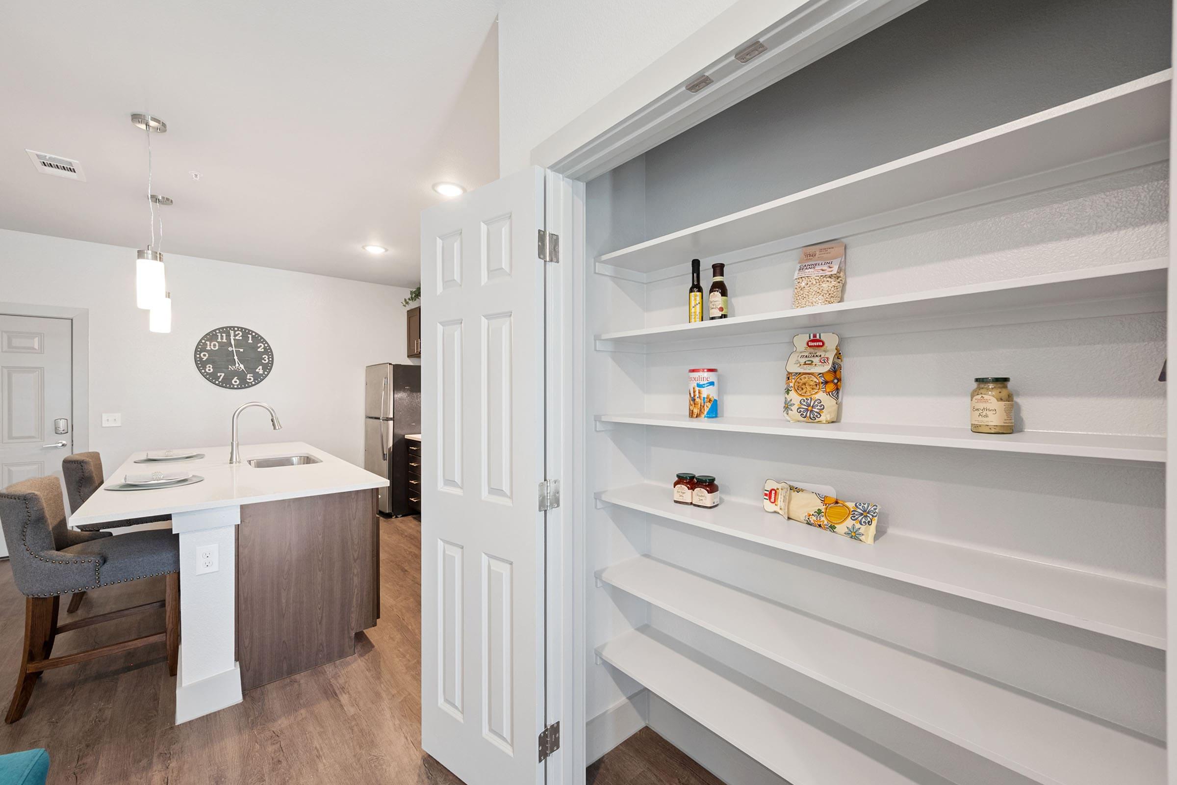 a room with a sink and a refrigerator