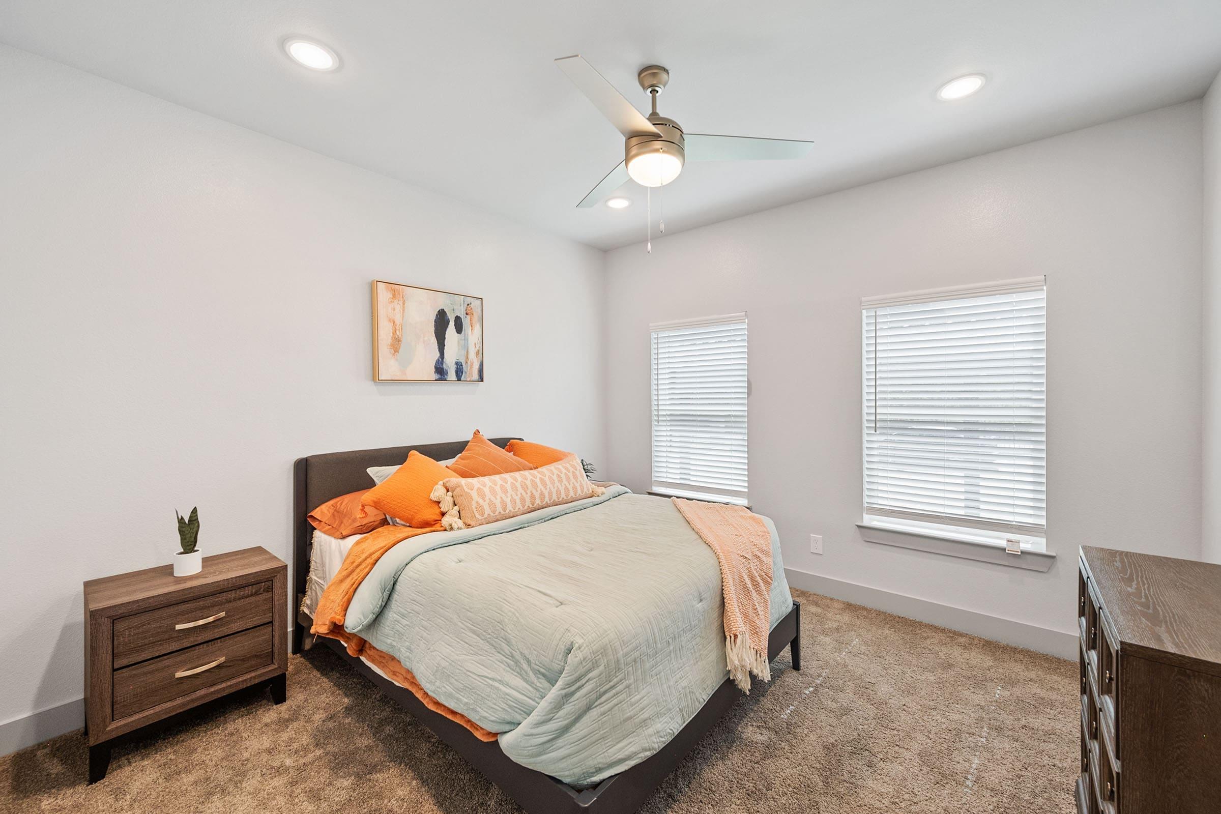 a bedroom with a bed and desk in a room