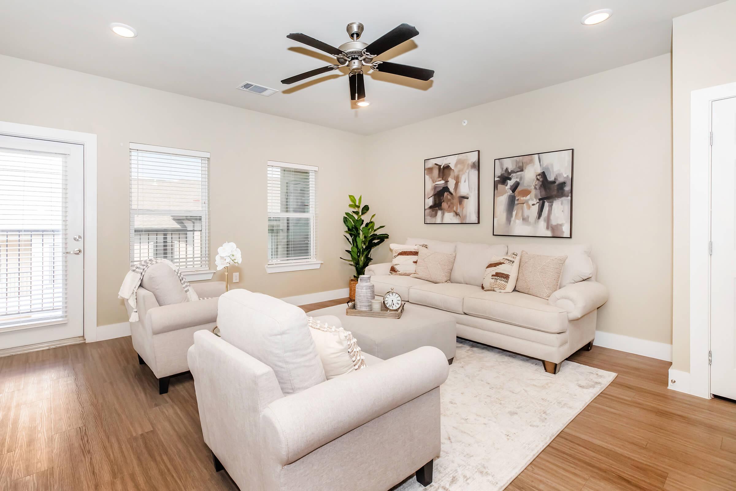 a living room filled with furniture and a large window