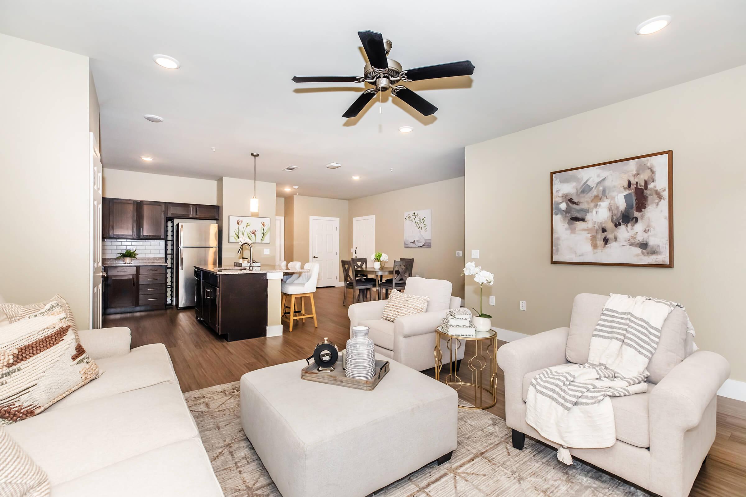 a living room filled with furniture and a flat screen tv