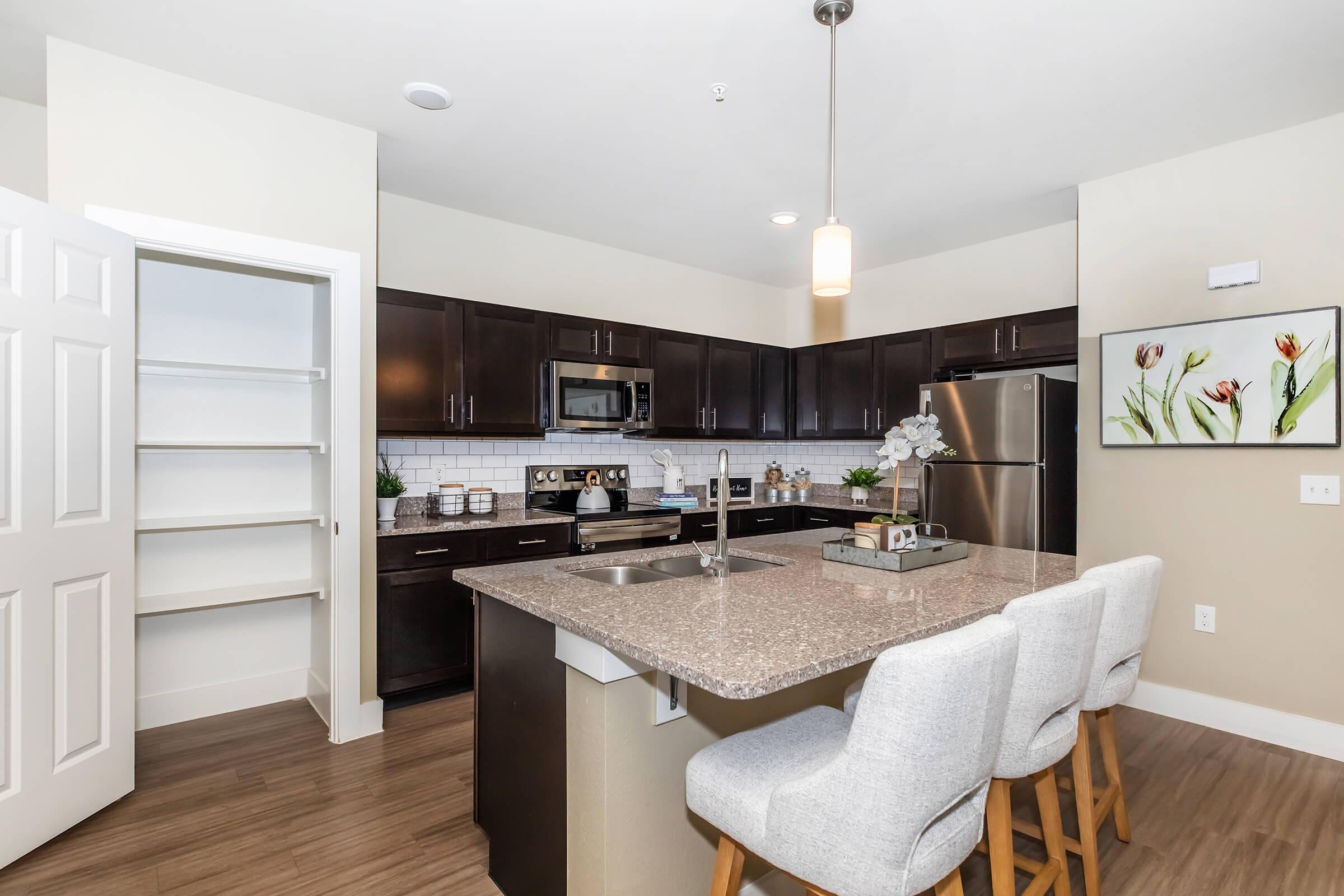 a kitchen with an island in the middle of a room