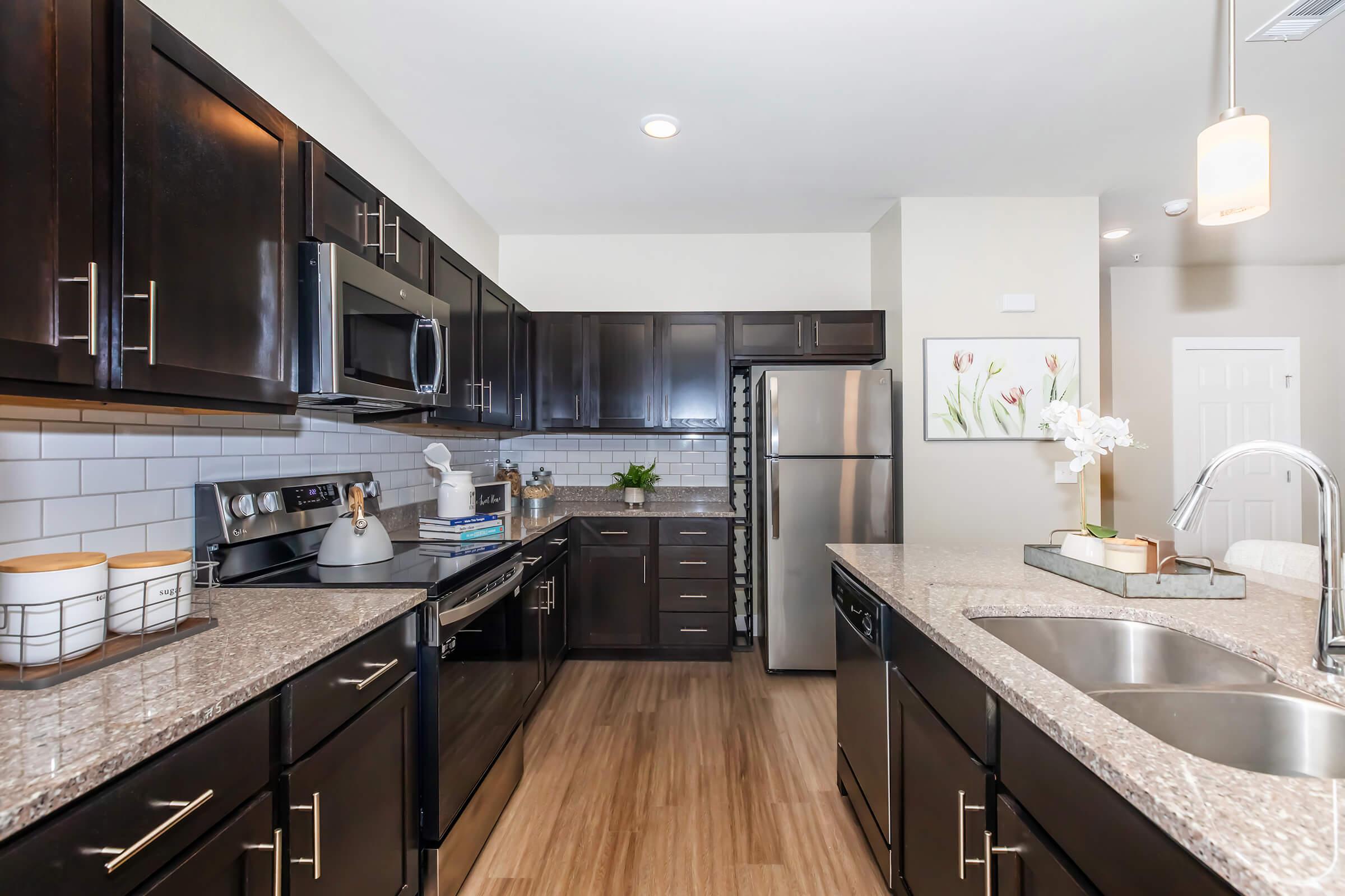 a modern kitchen with stainless steel appliances and wooden cabinets