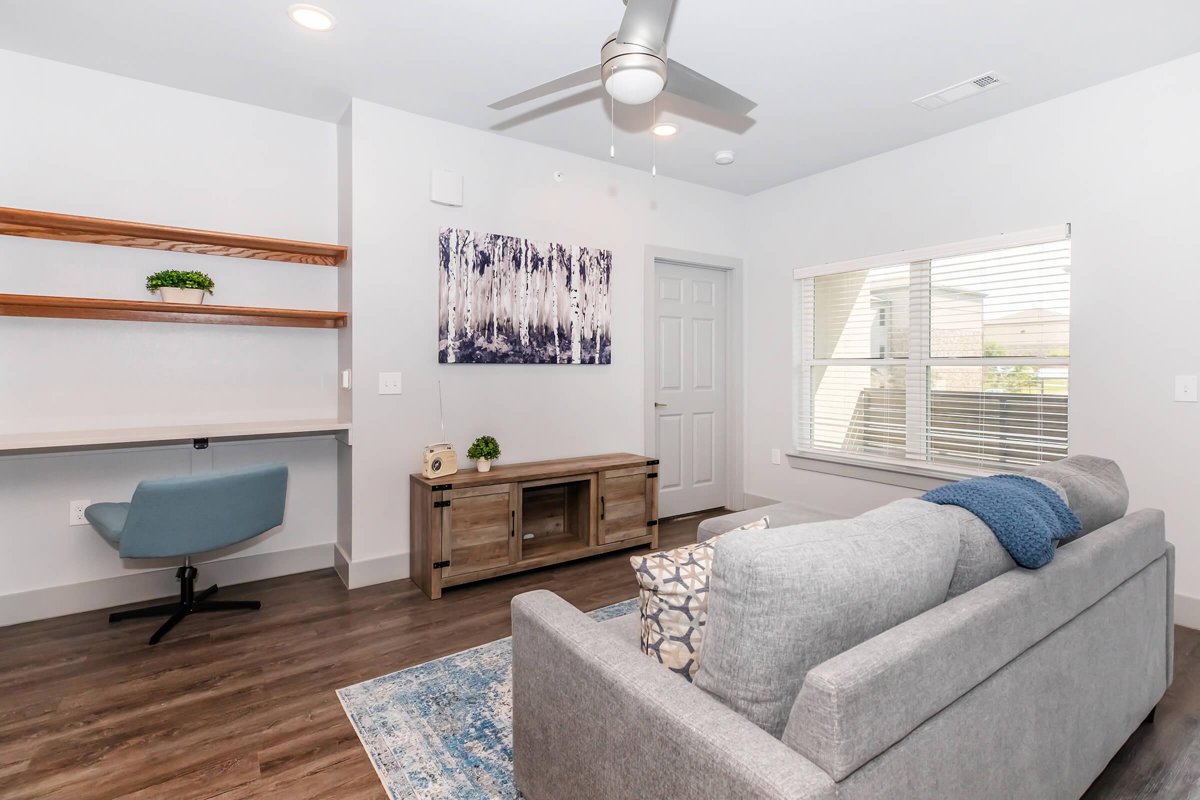 a living room filled with furniture and a flat screen tv