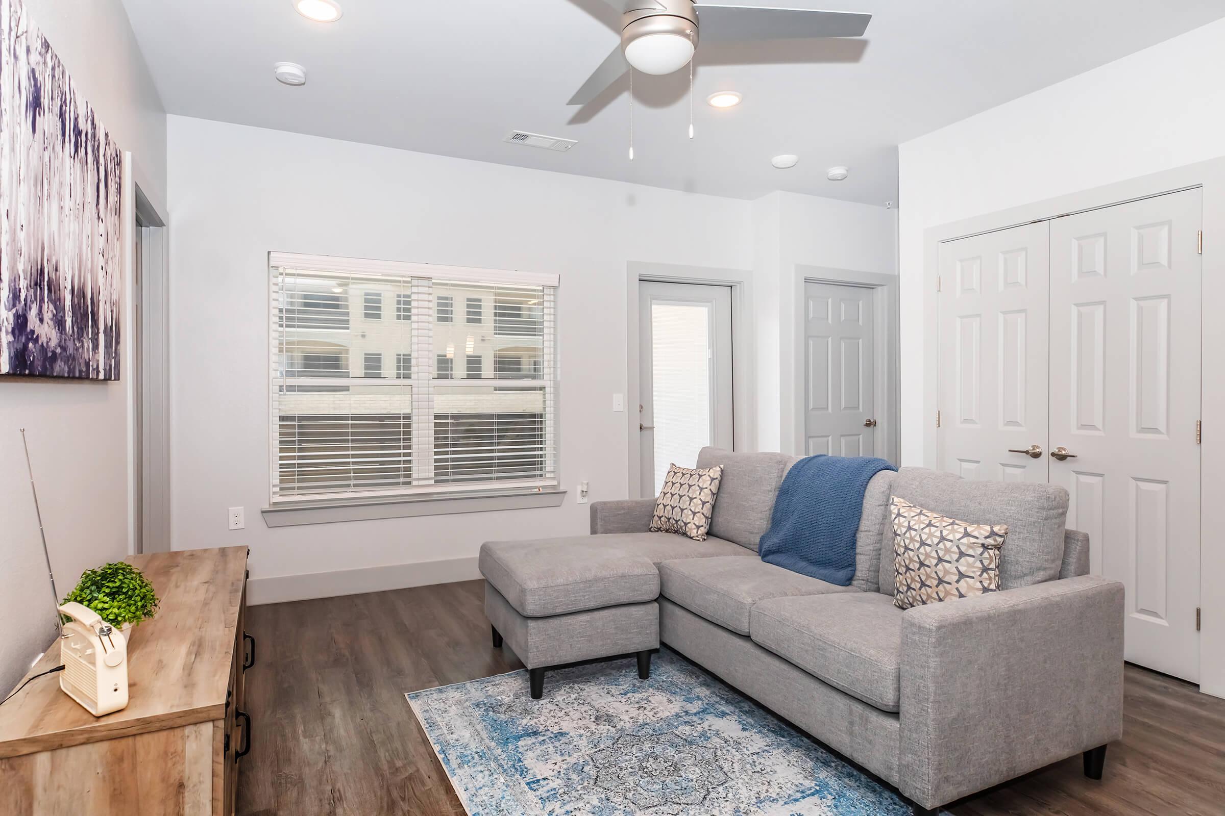 a living room filled with furniture and a large window