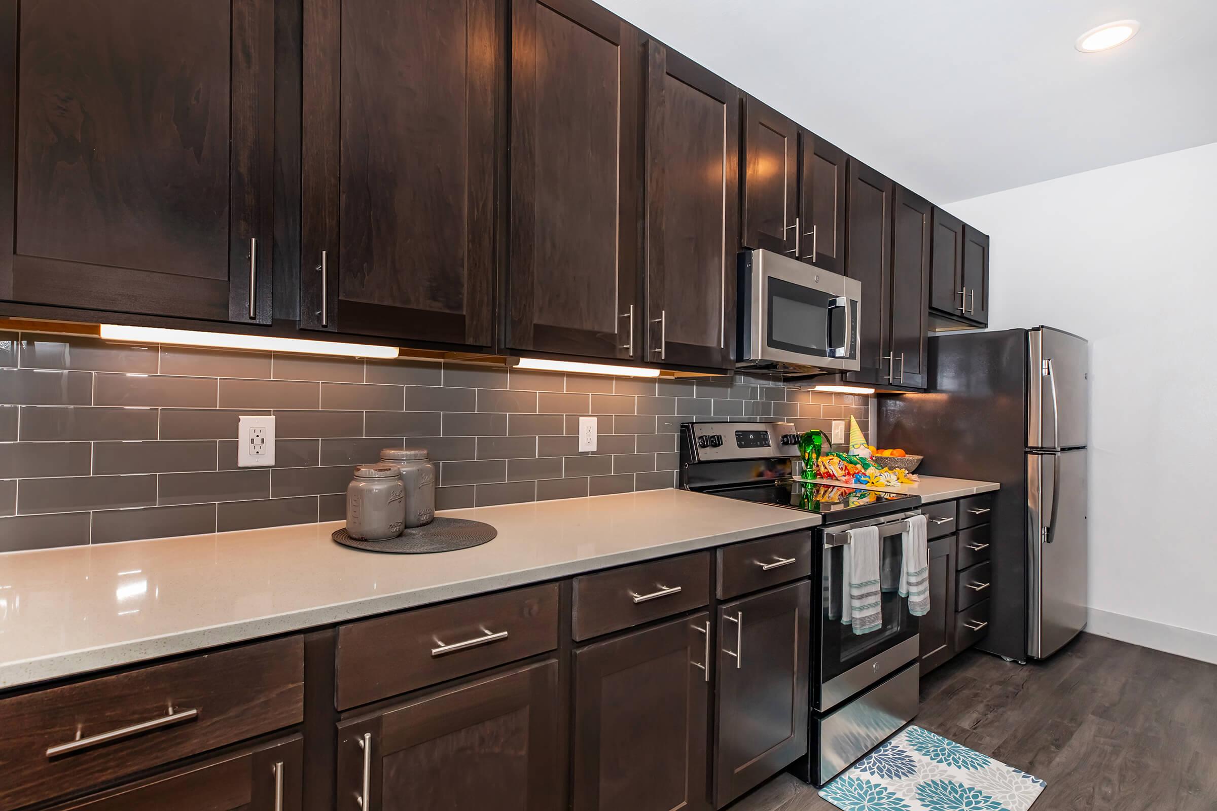 a kitchen with stainless steel appliances and wooden cabinets