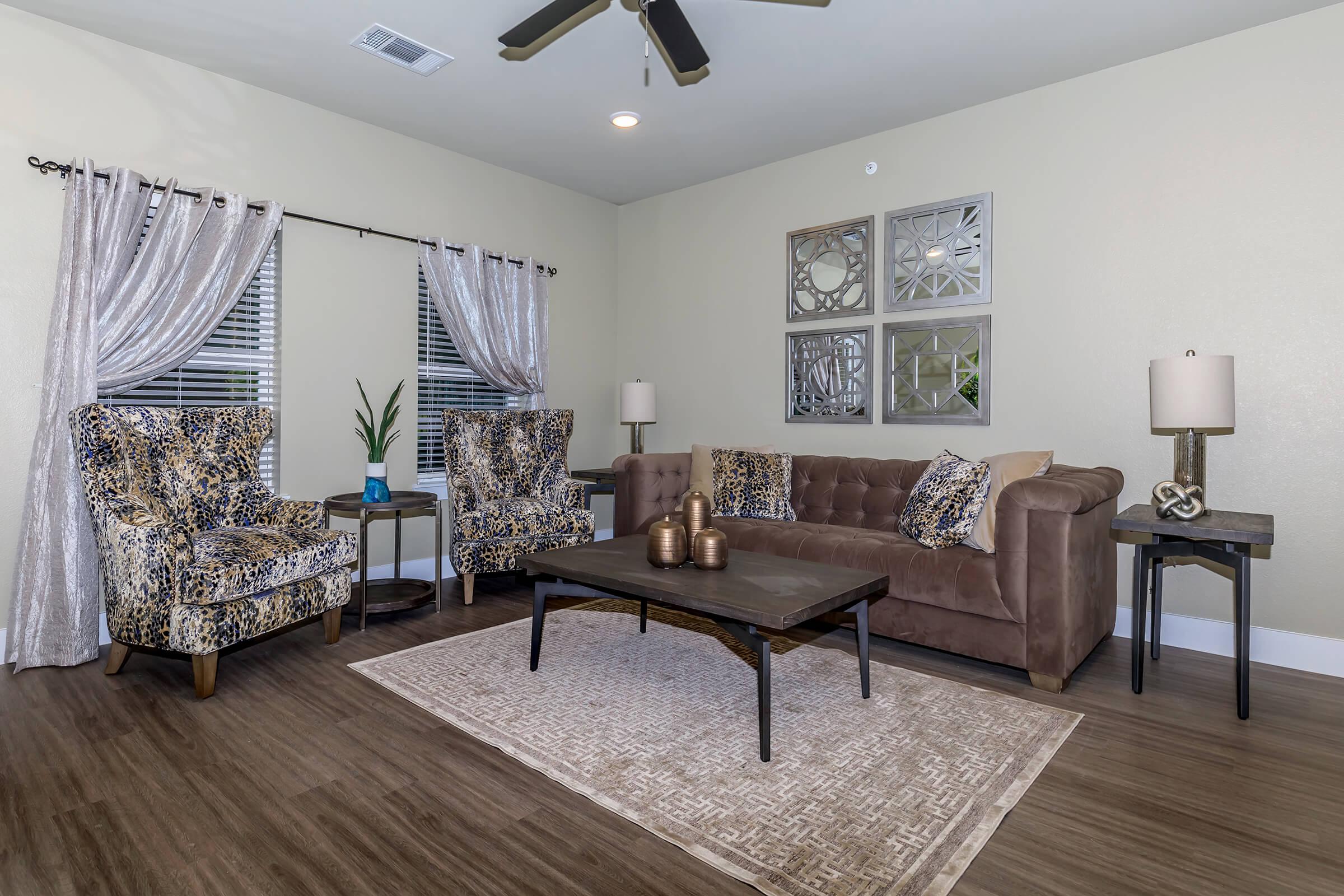 a living room filled with furniture and a large window