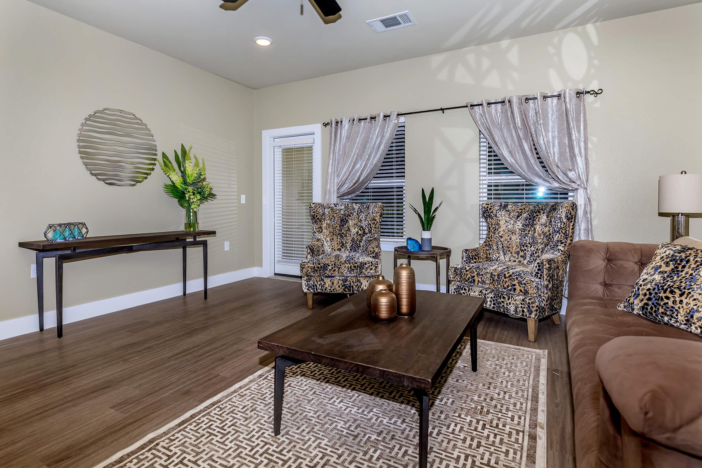 a living room filled with furniture and a large window