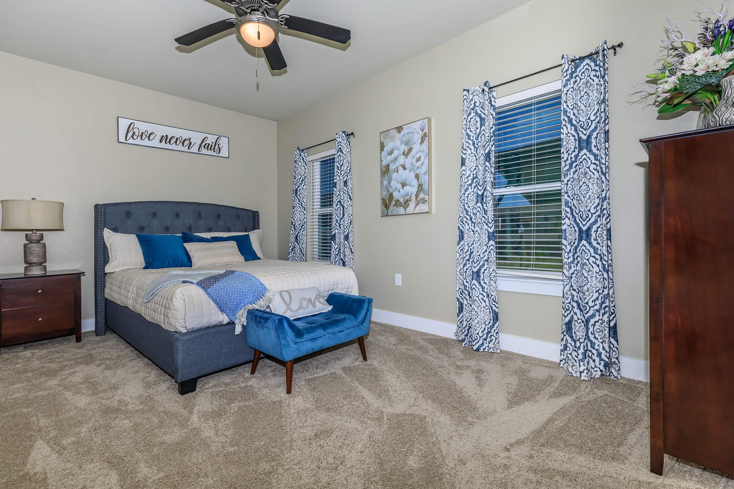 a bedroom with a bed and desk in a room