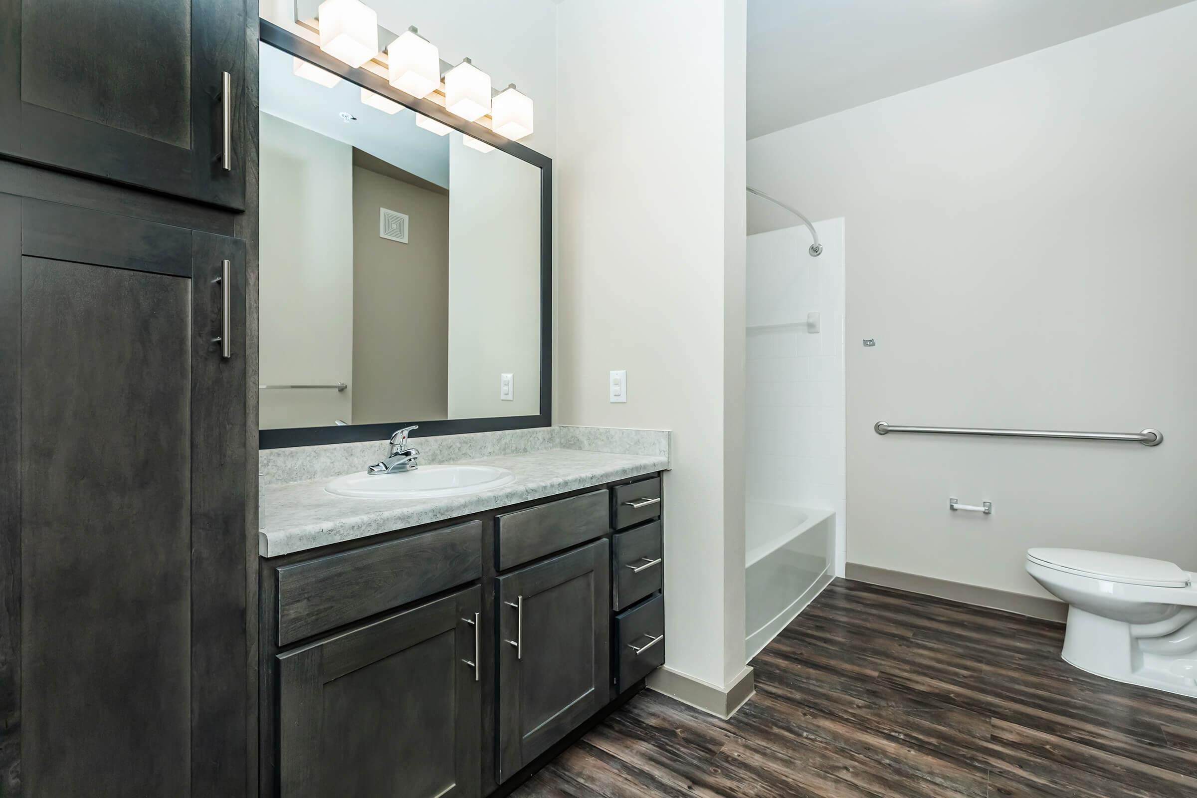 a kitchen with a sink and a mirror