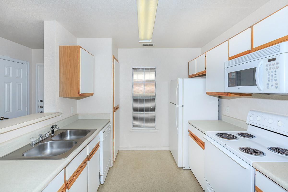 a kitchen with a stove a sink and a microwave