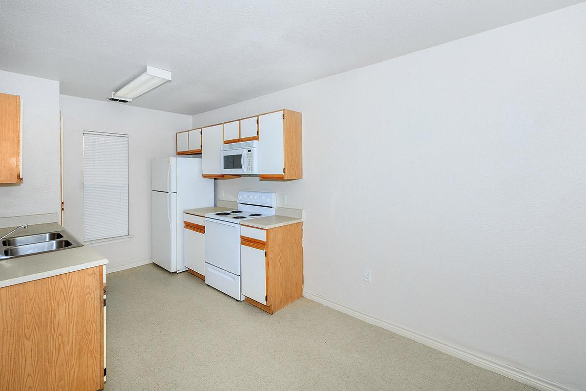 a white refrigerator freezer sitting inside of a kitchen