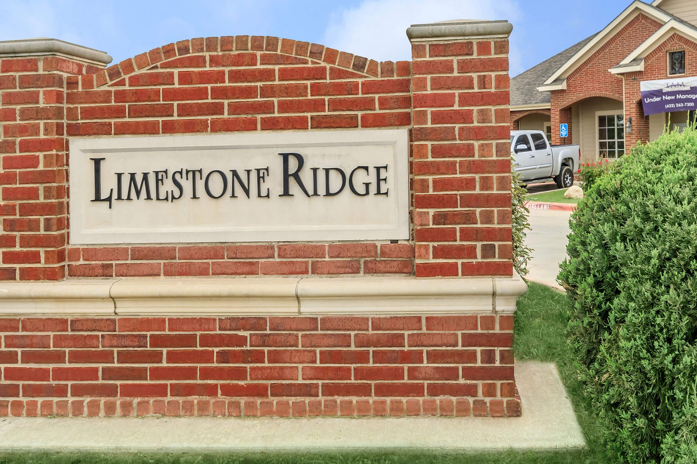 a sign in front of a brick building