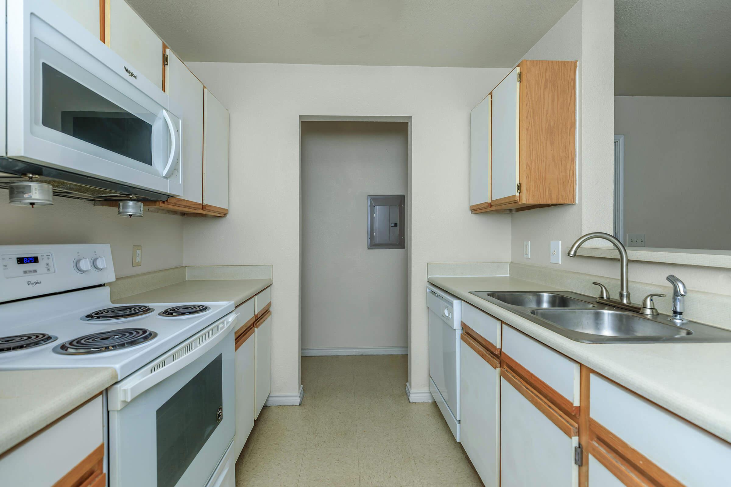 a kitchen with a stove a sink and a microwave