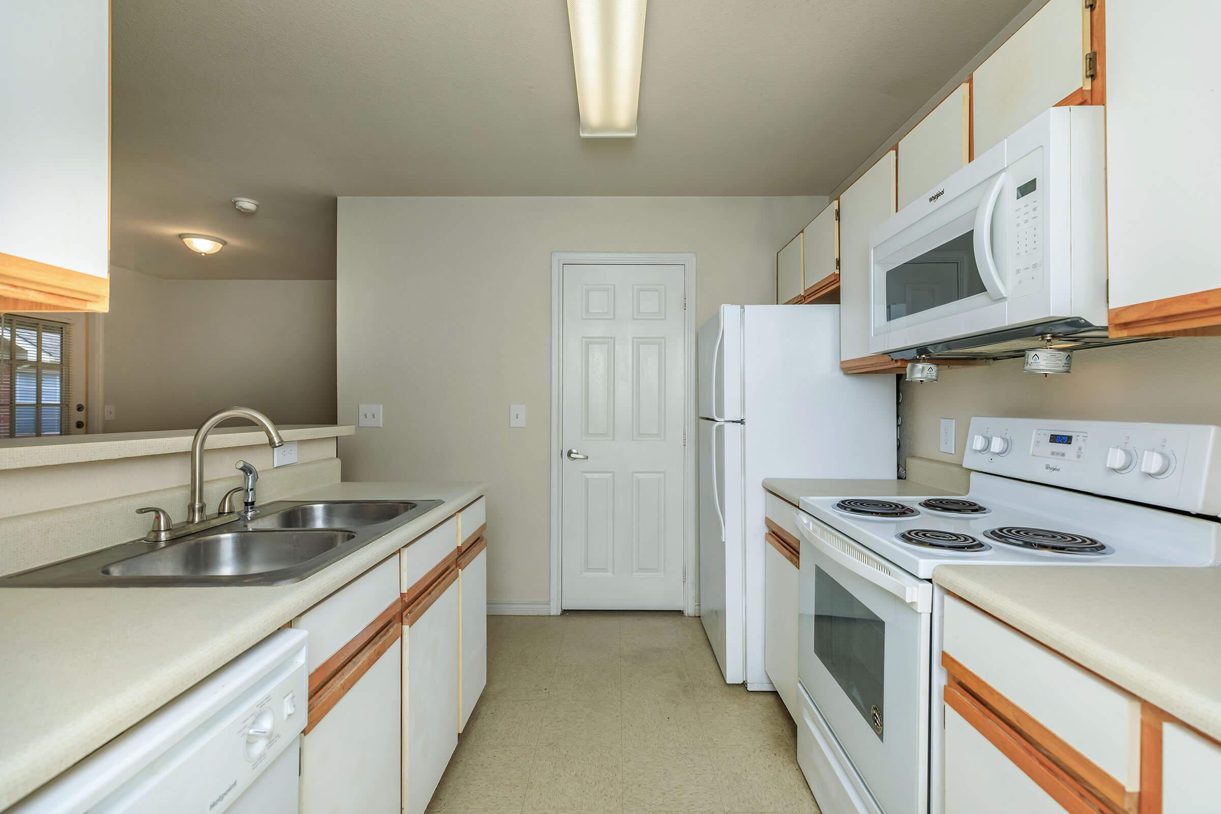 a kitchen with a sink and a mirror