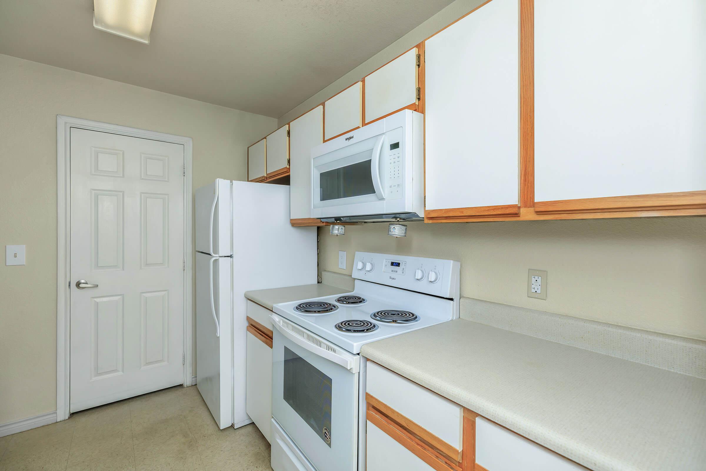 a stove top oven sitting inside of a kitchen