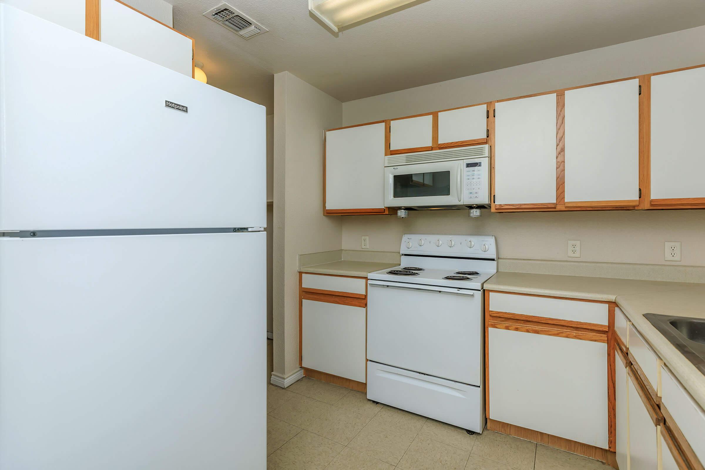 a kitchen with a stove and a refrigerator