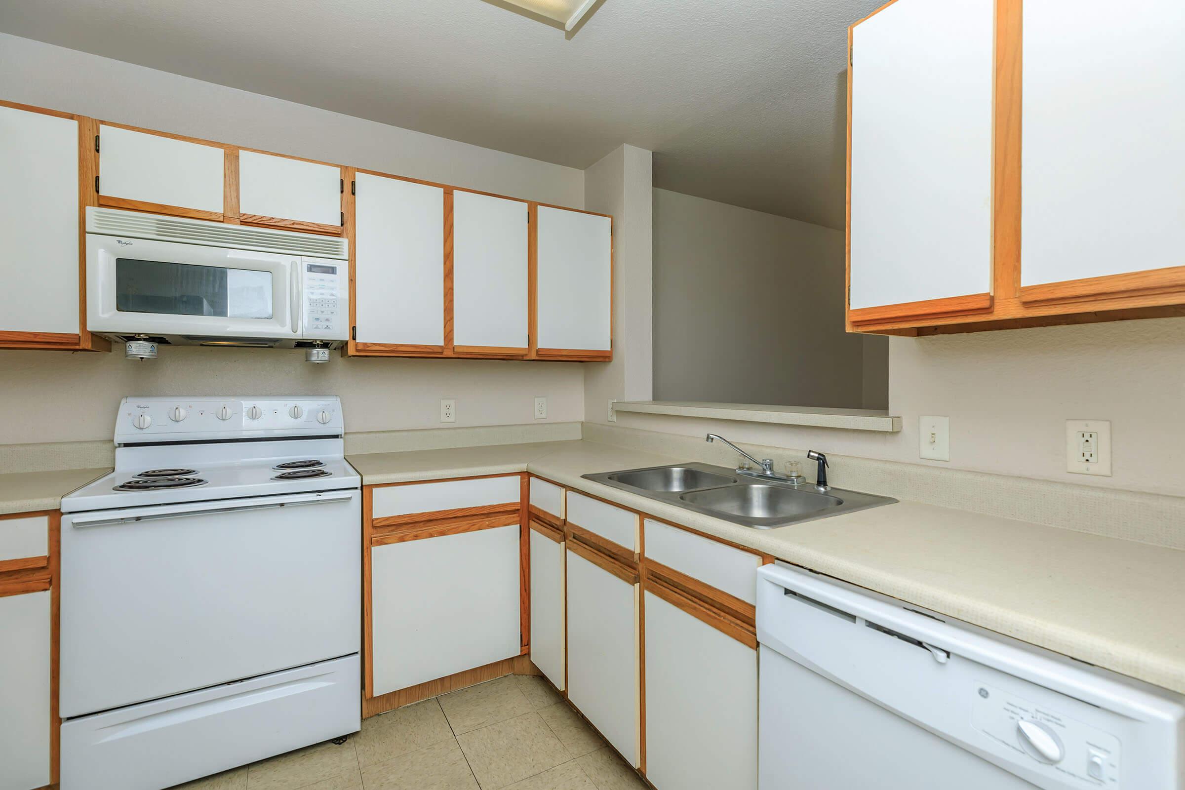 a kitchen with a stove a sink and a microwave