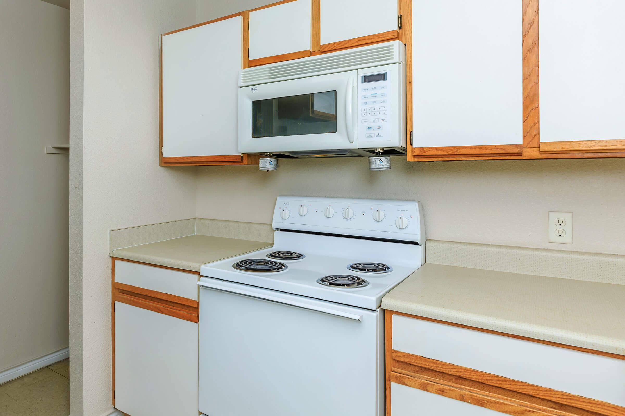 a microwave oven sitting on top of a stove