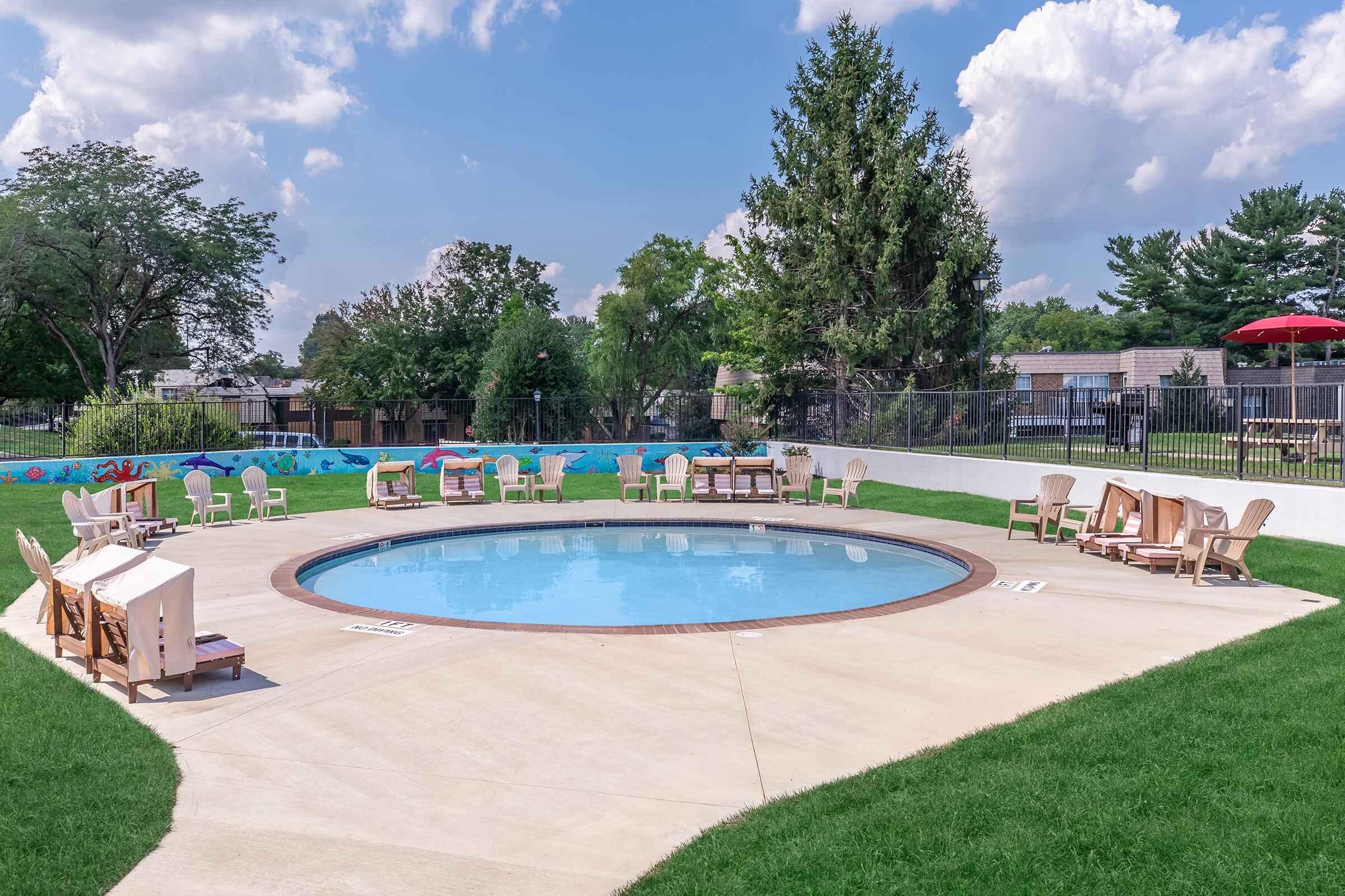 a group of lawn chairs sitting next to a pool