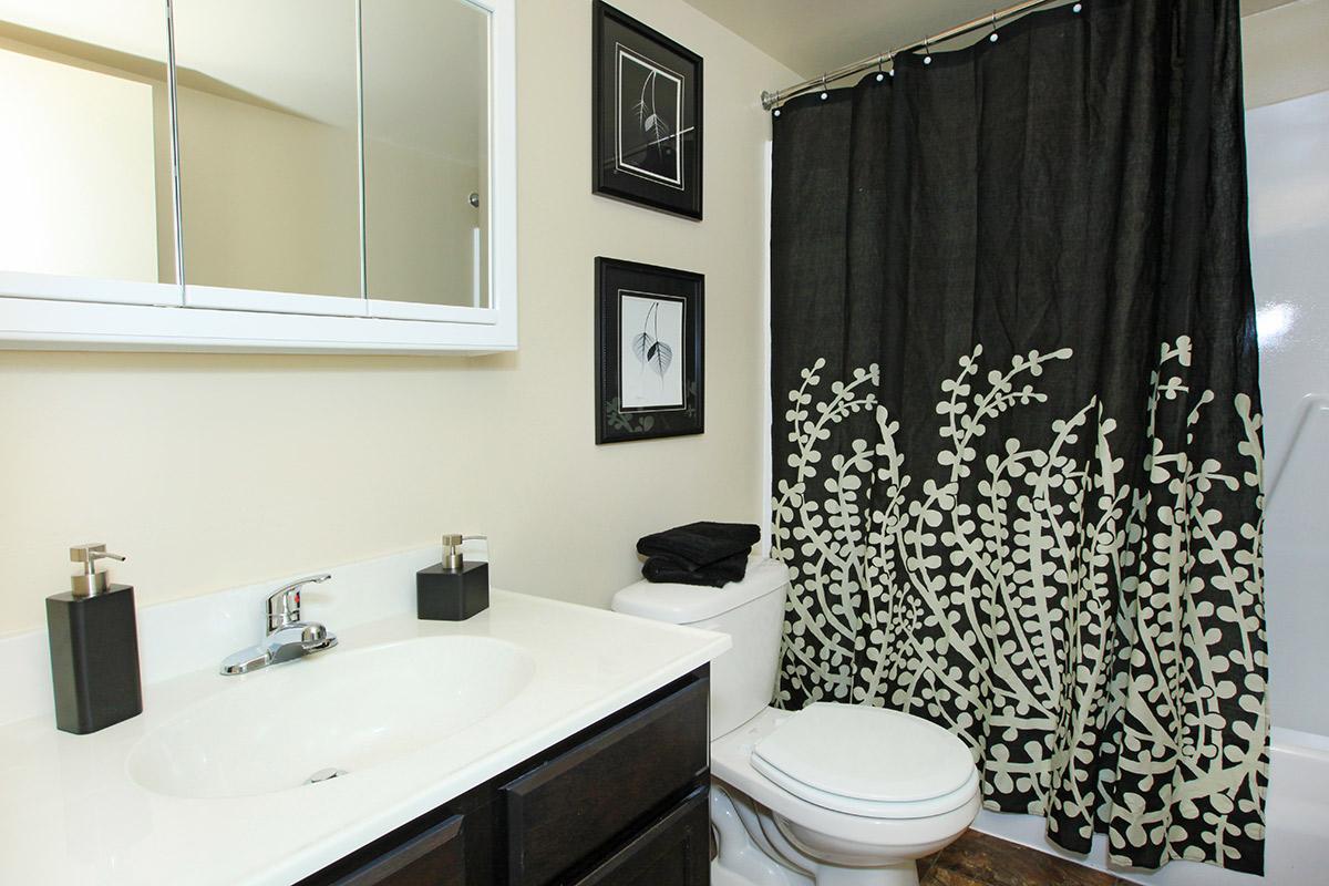 a white sink and shower curtain