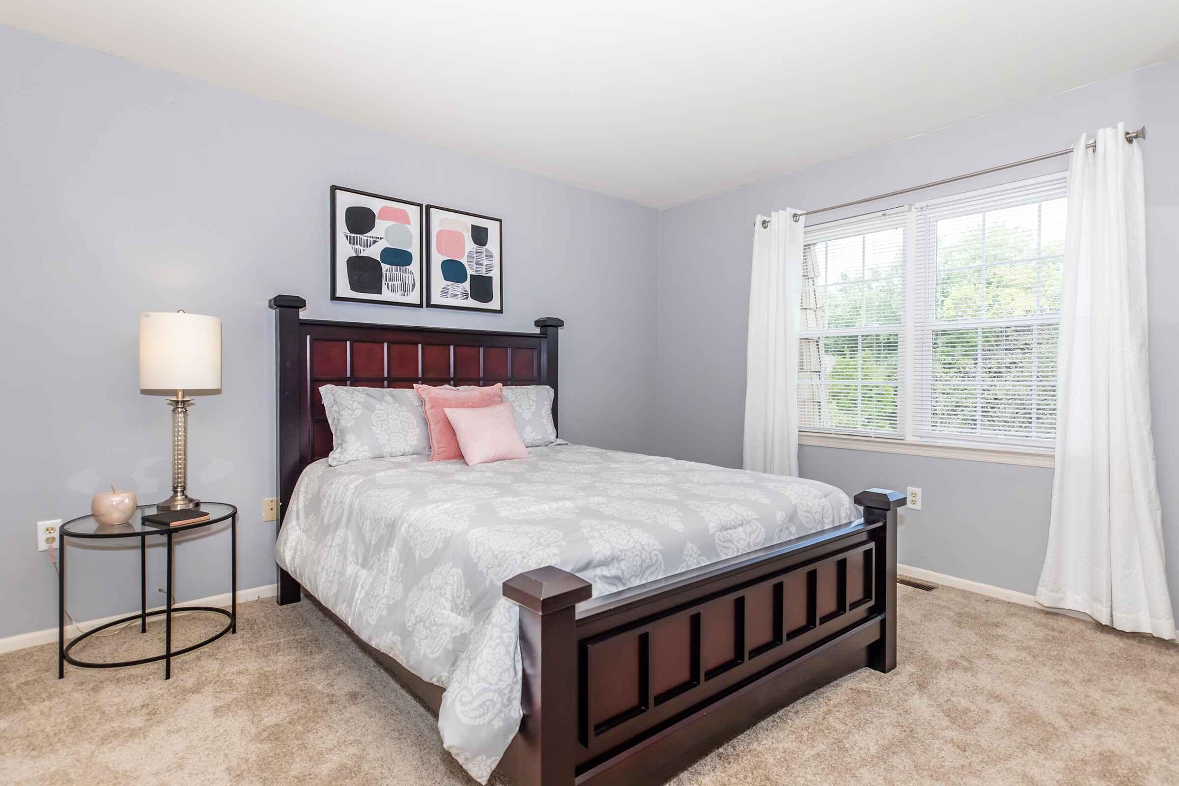 a bedroom with a bed and desk in a room