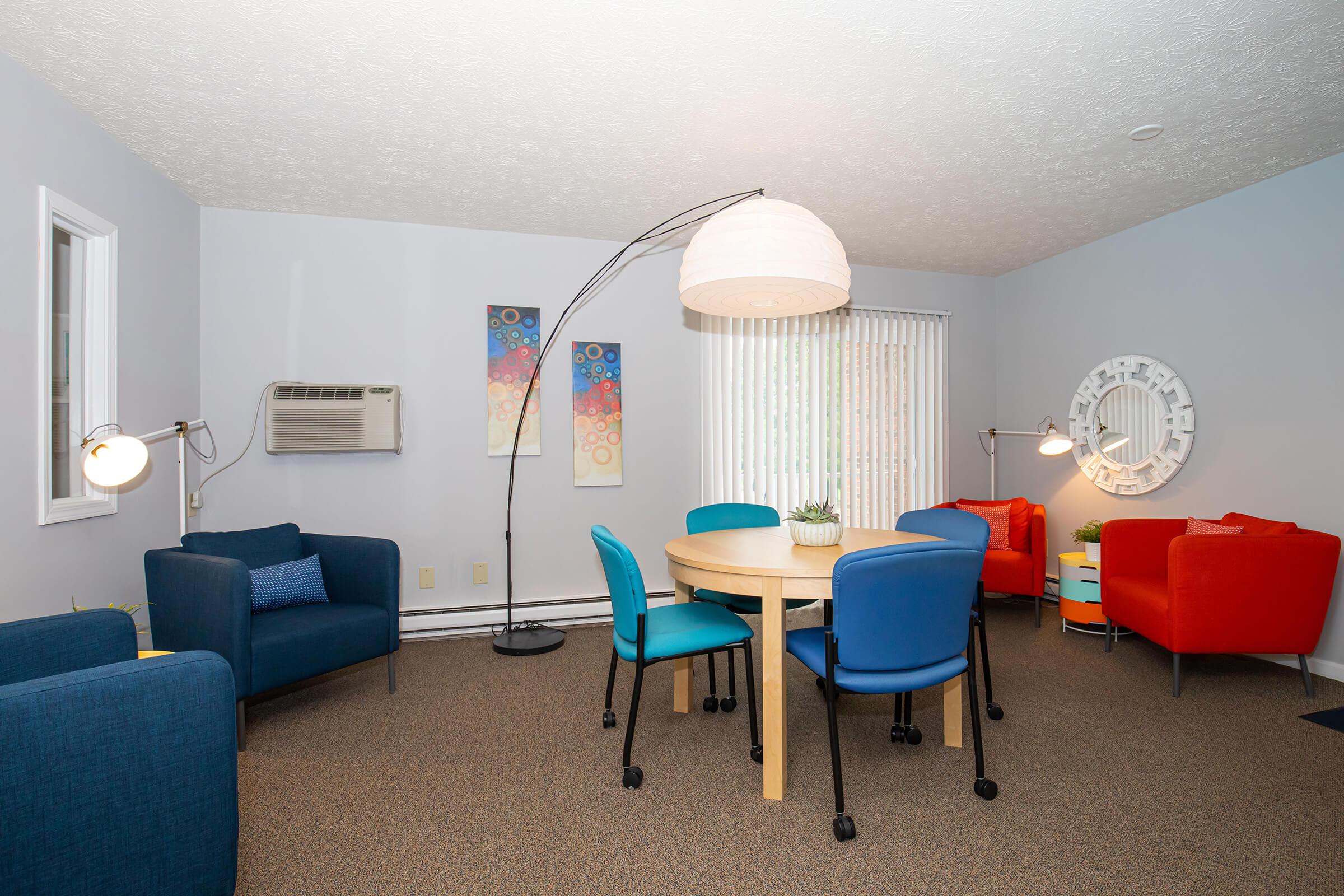 a living room filled with furniture and a blue chair