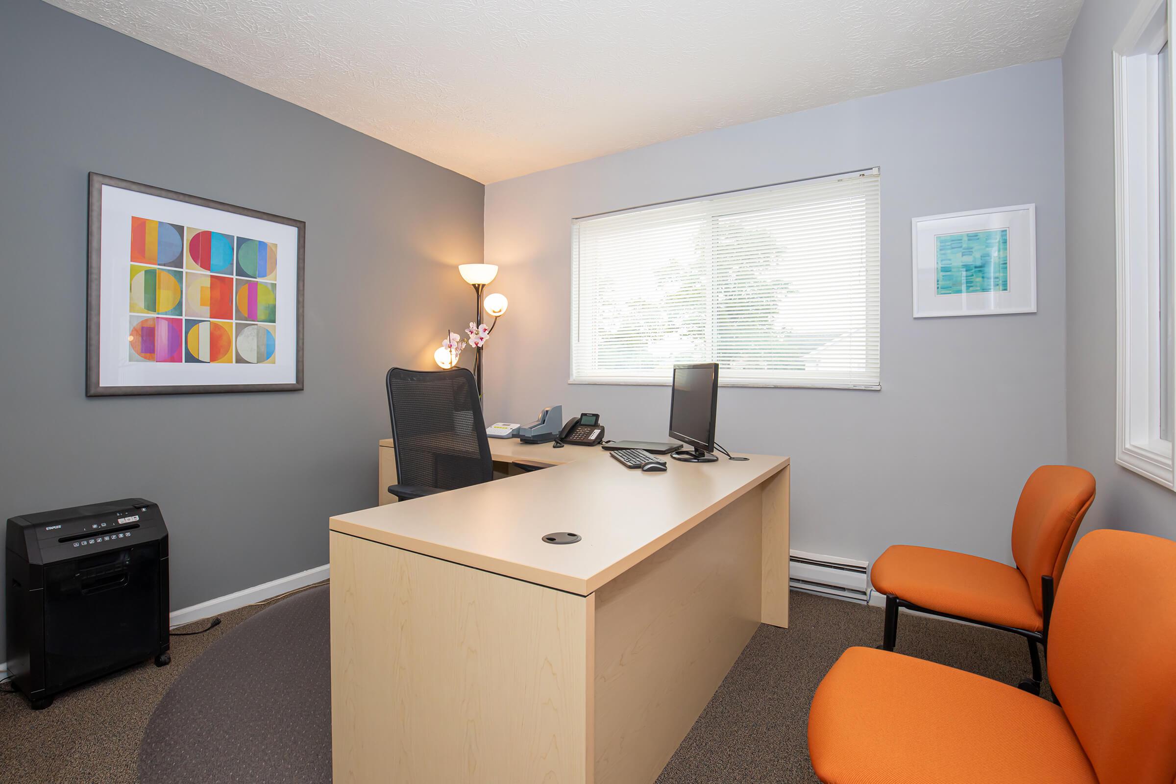 a bedroom with a bed and desk in a small room