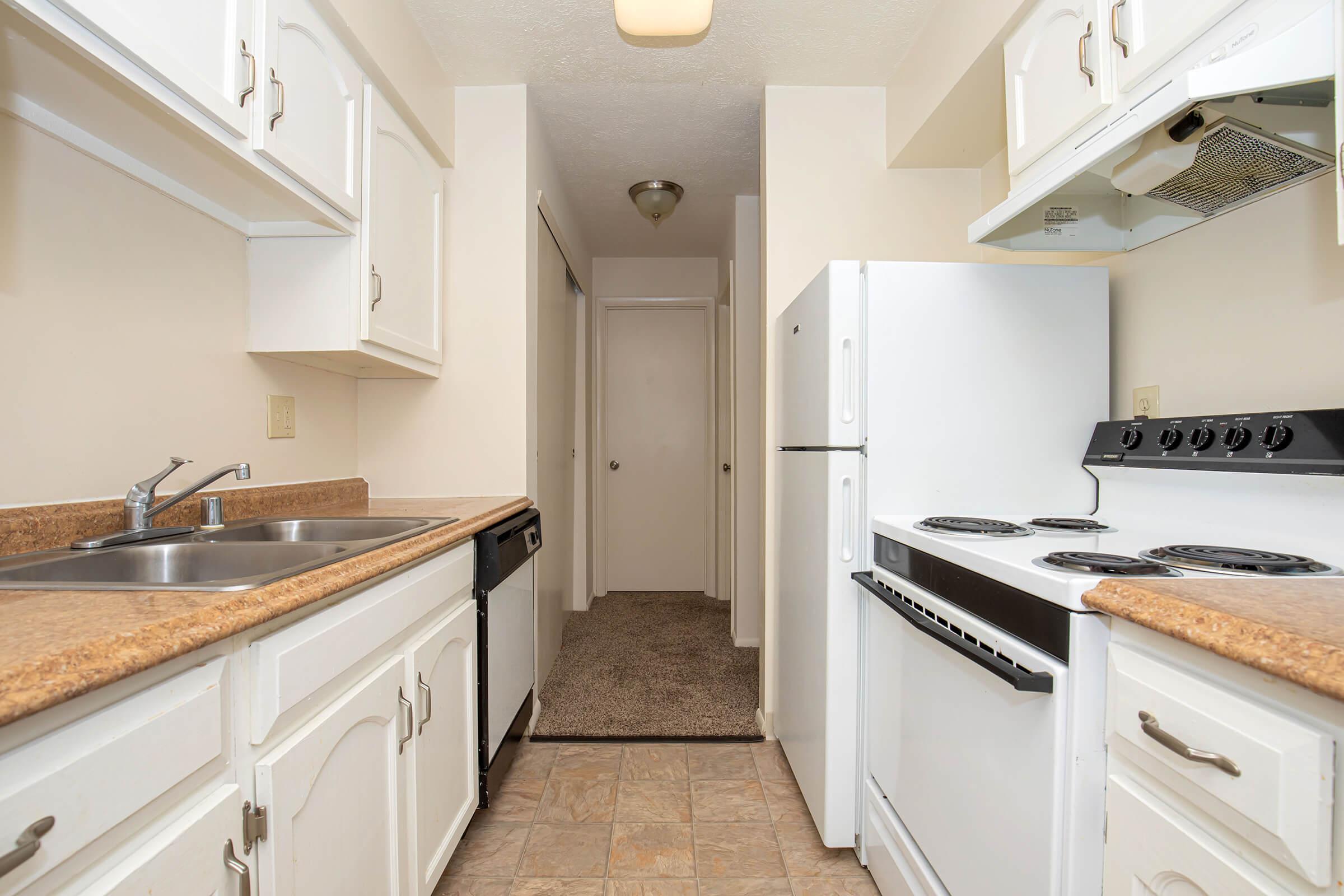 a kitchen with a stove and a sink