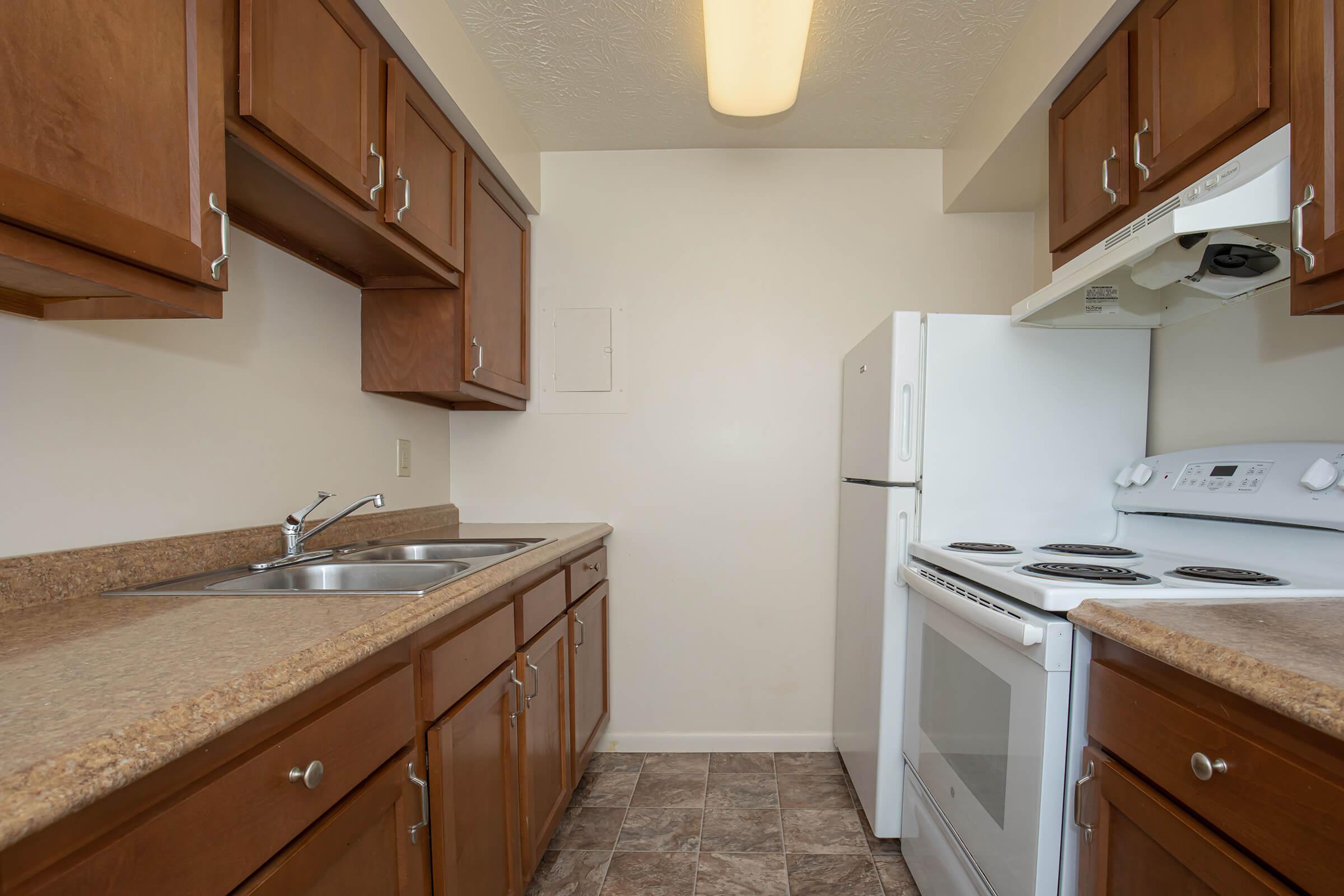 a kitchen with a sink and a refrigerator