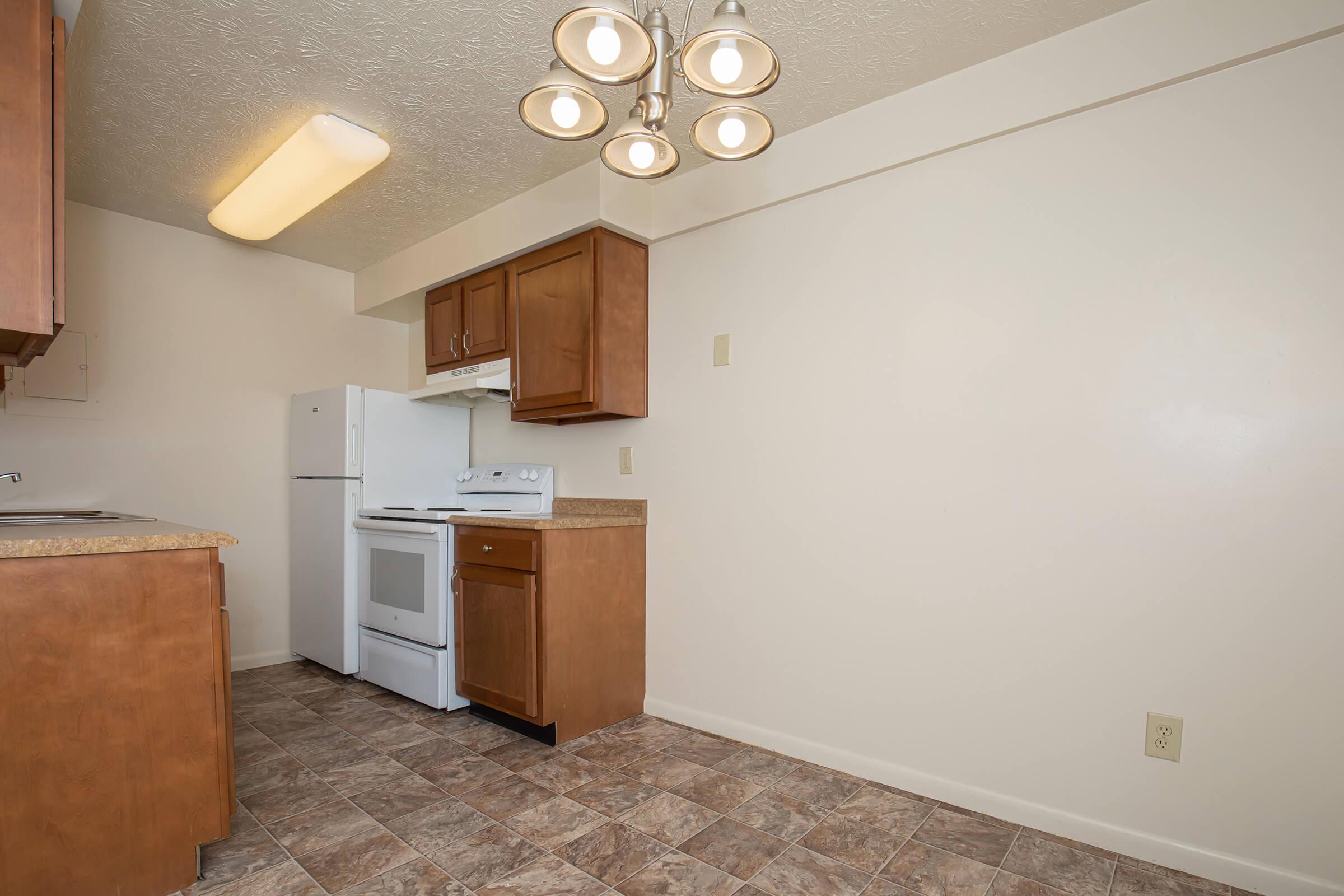 a kitchen with a sink and a refrigerator